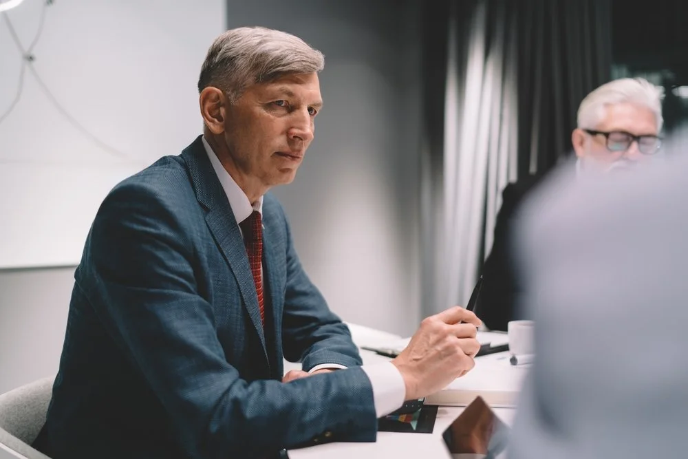 Senior corporate communications consultant in a strategic advisory meeting with an executive in Melbourne