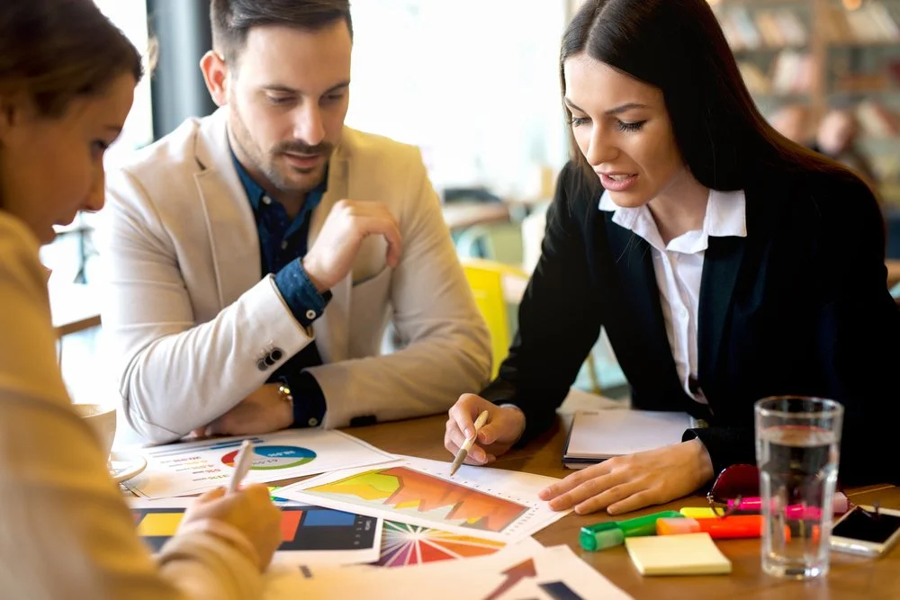 Team of stakeholder engagement consultants collaborating on a relationship mapping strategy for a complex organisation