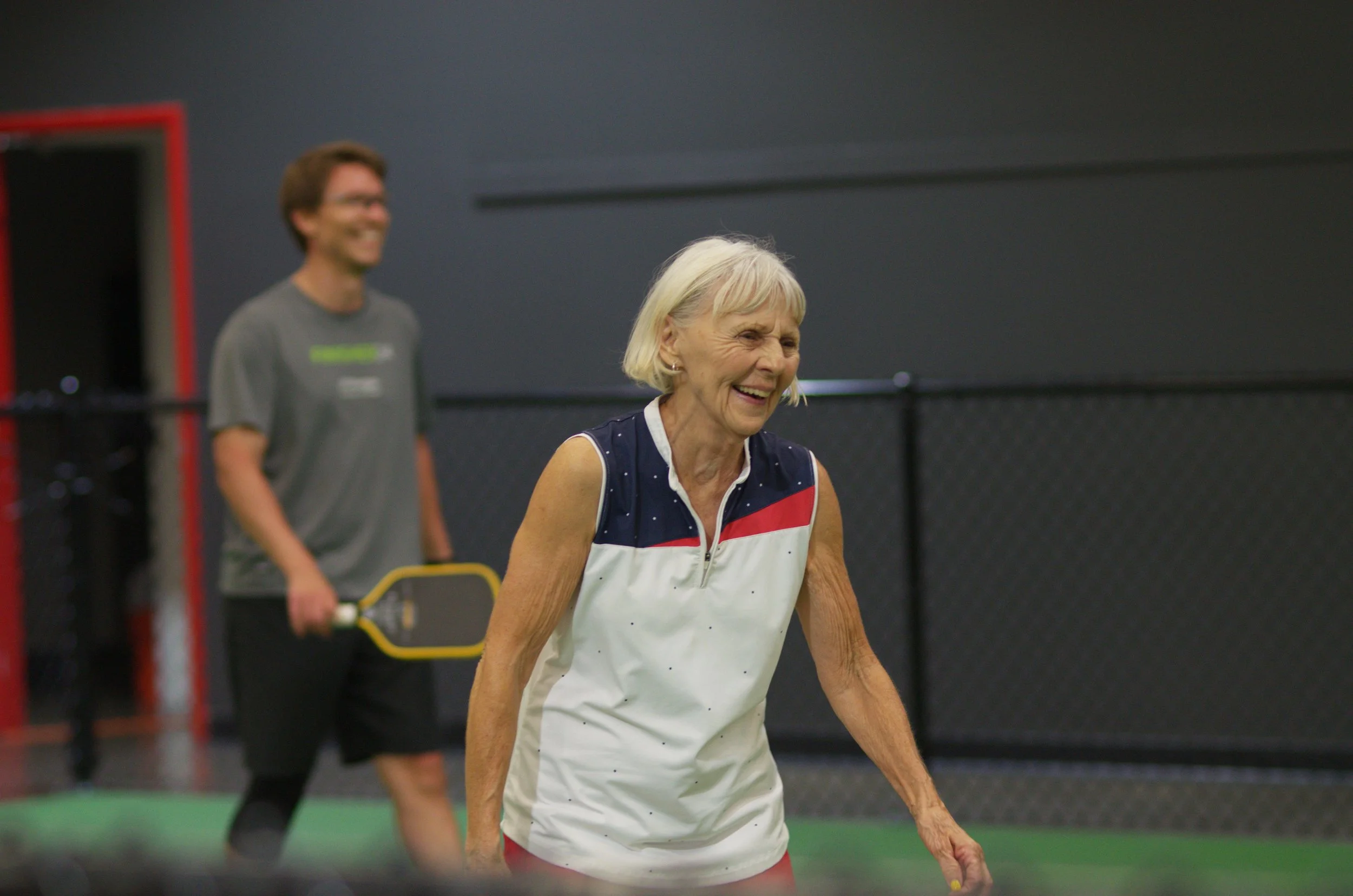 Two smiling pickleball players