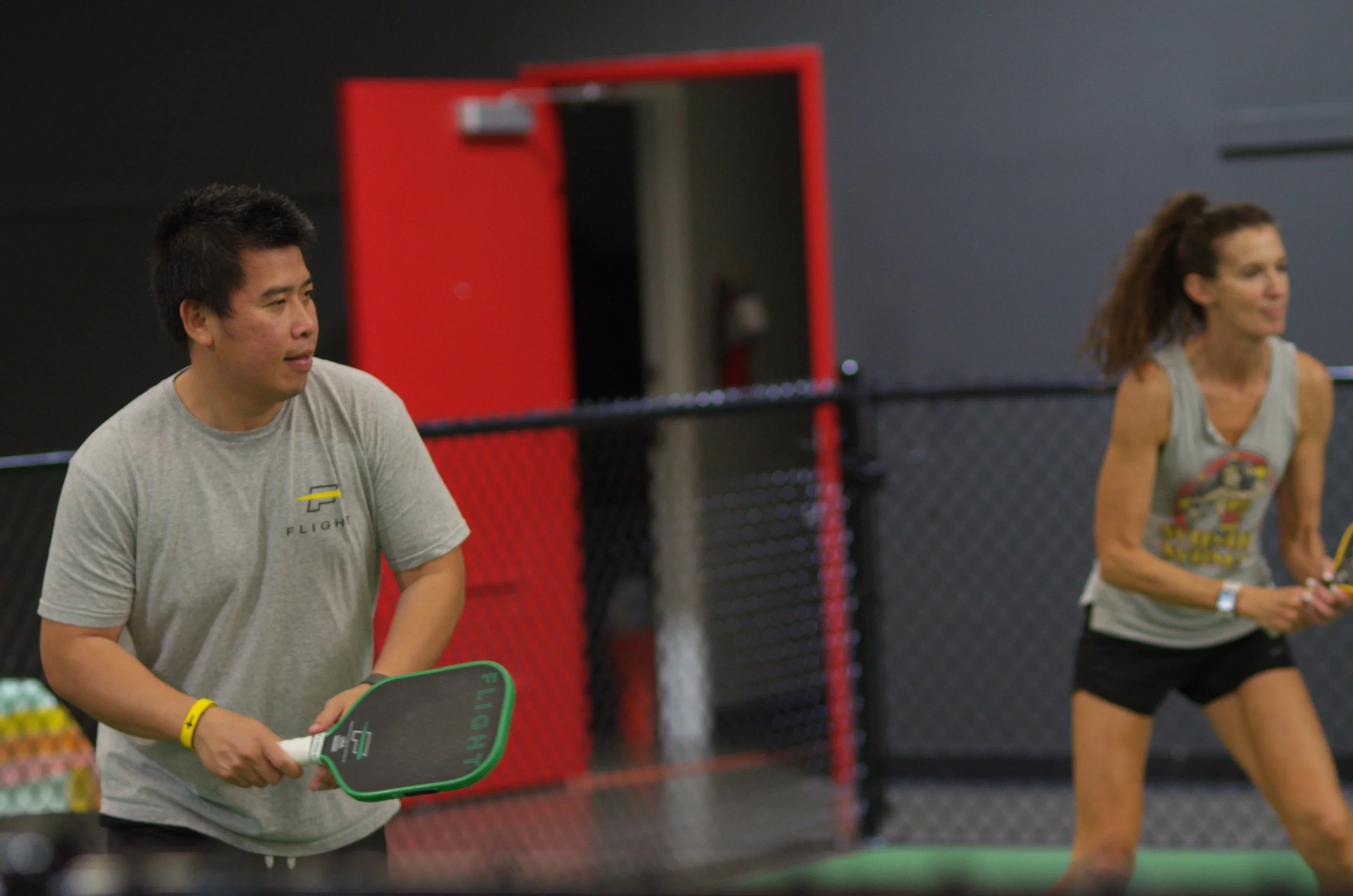 Noi Sourinthone on-court with a student
