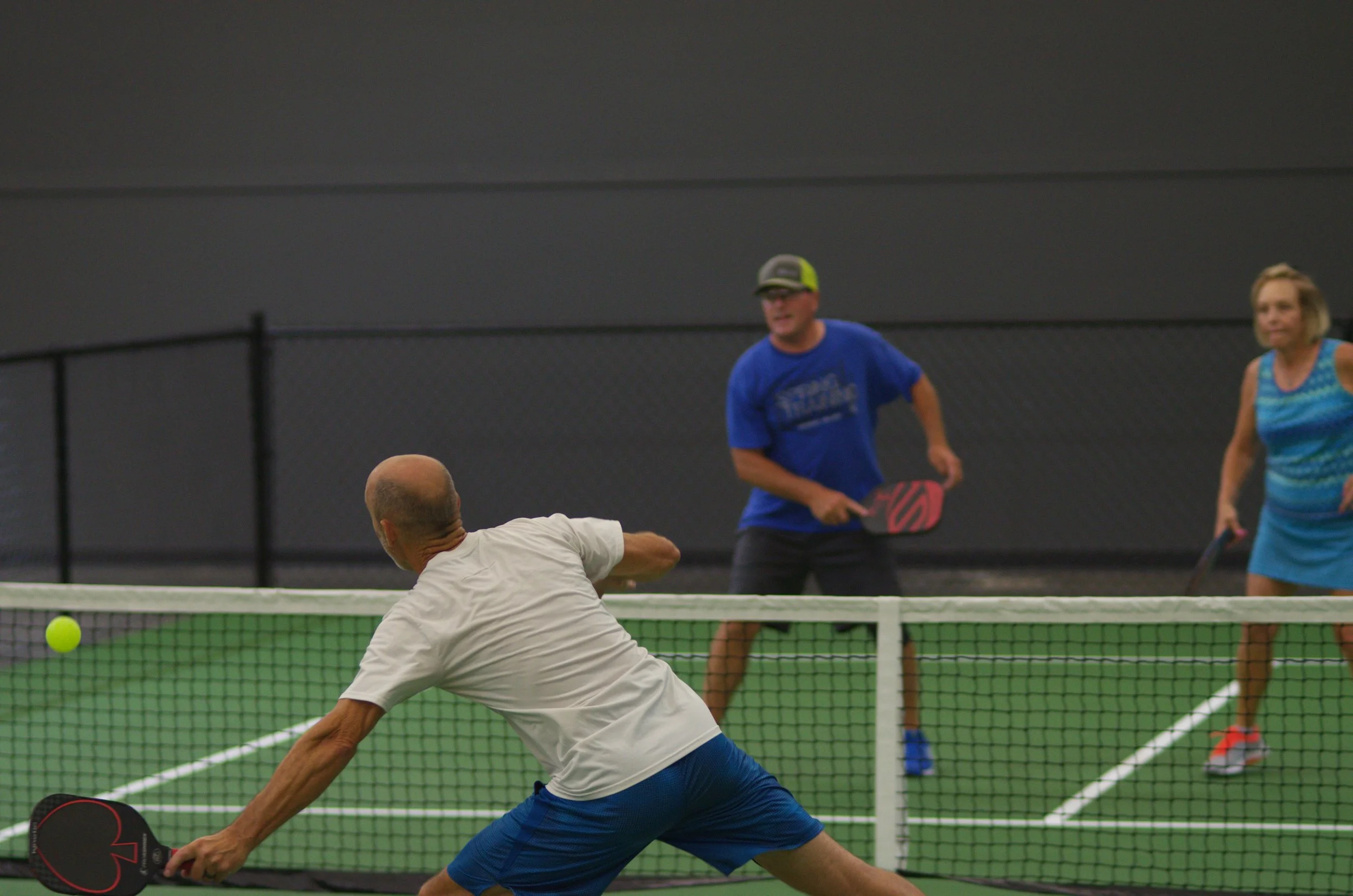 Three pickleball players participating in league