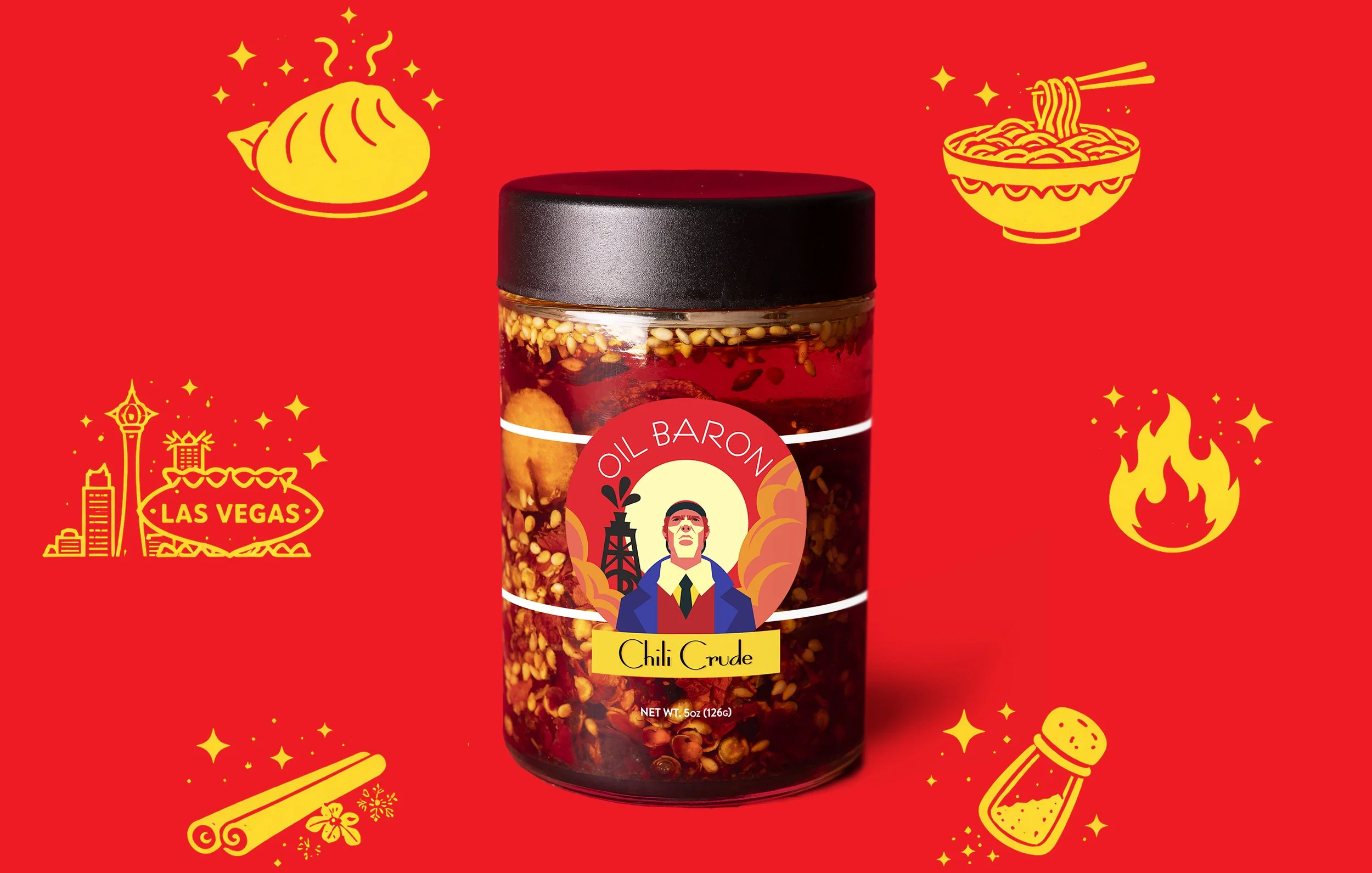 A jar of Oil Baron chili crude with chili flakes and seeds visible inside, on a red background with yellow illustrations of Las Vegas landmarks, a steaming dumpling, a bowl of noodles, a fire, a salt shaker, and festive decorations.
