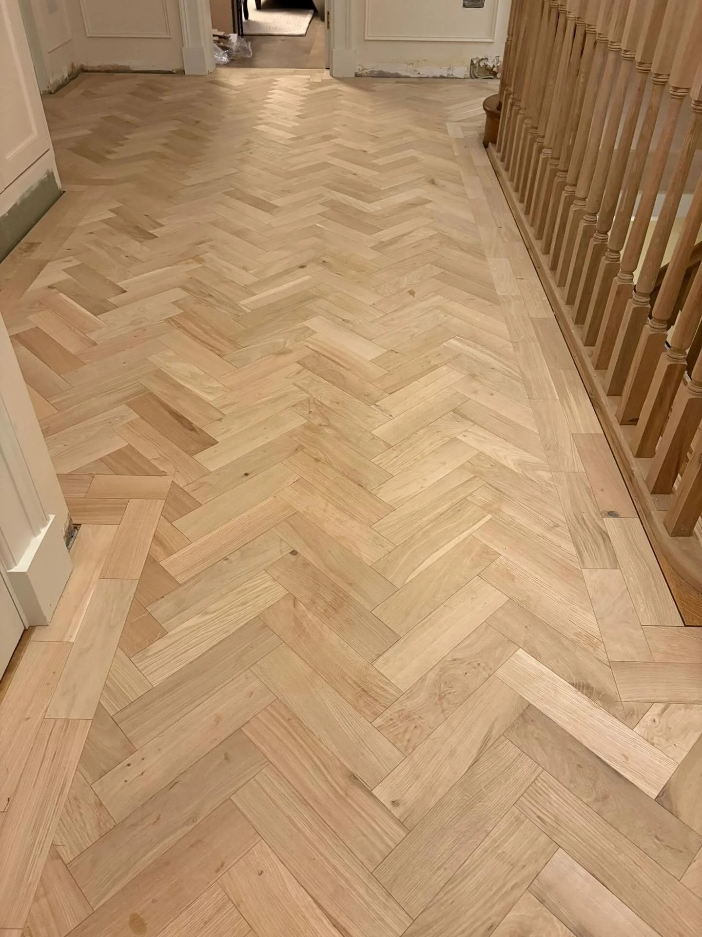 For this beautiful property, we installed an unfinished oak herringbone floor, complete with a two-block border and handcrafted matching ramp thresholds. The result is a classic, heritage-style floor that adds warmth and character to this home.
