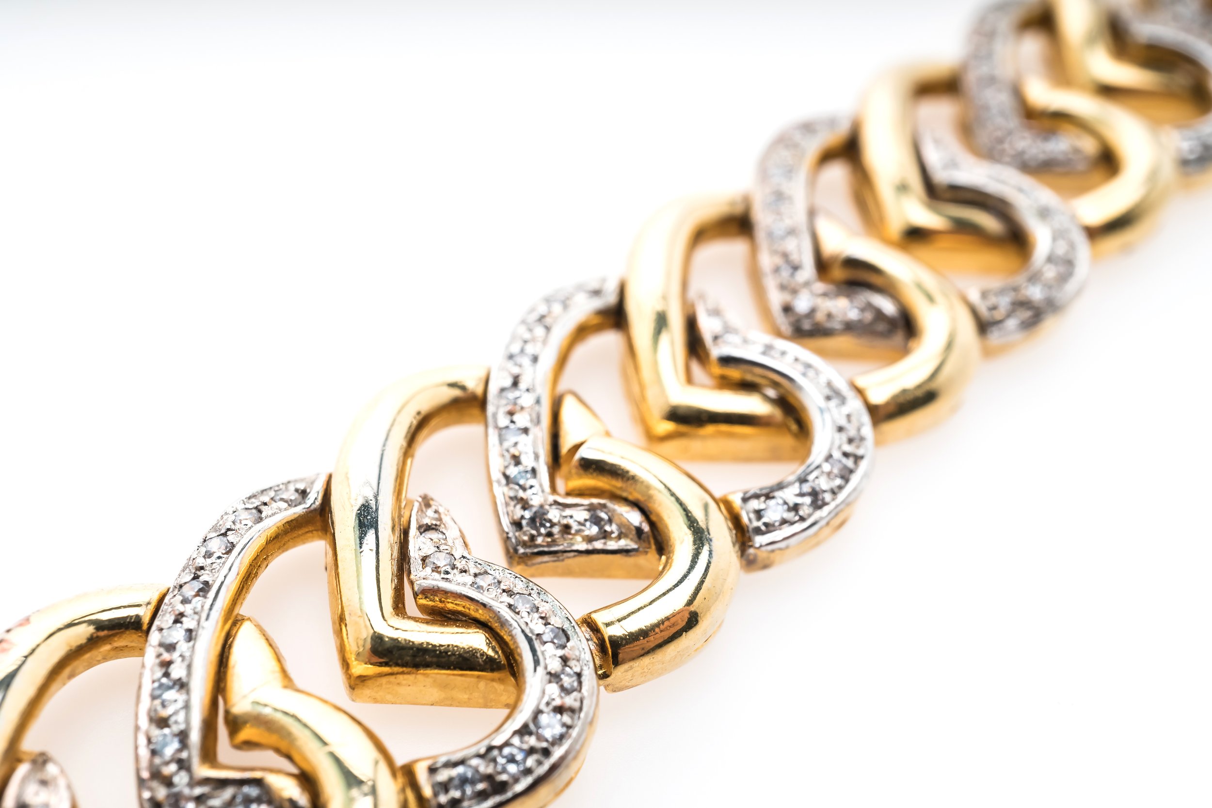 vecteezy_a-gold-and-diamond-bracelet-with-a-heart-shape_52617197.jpg