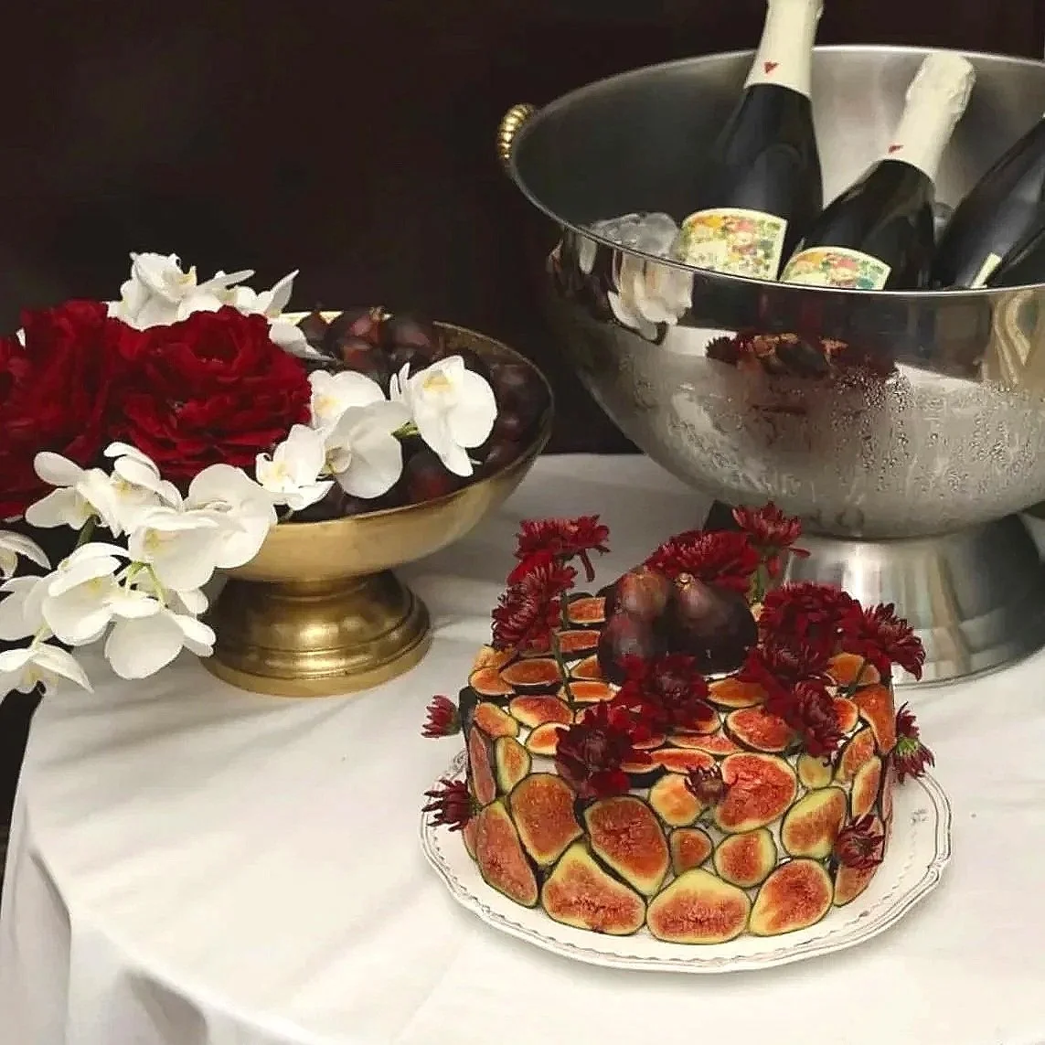 A white heart-shaped cake decorated with piped white frosting and the word 'engaged' written in black icing on top.