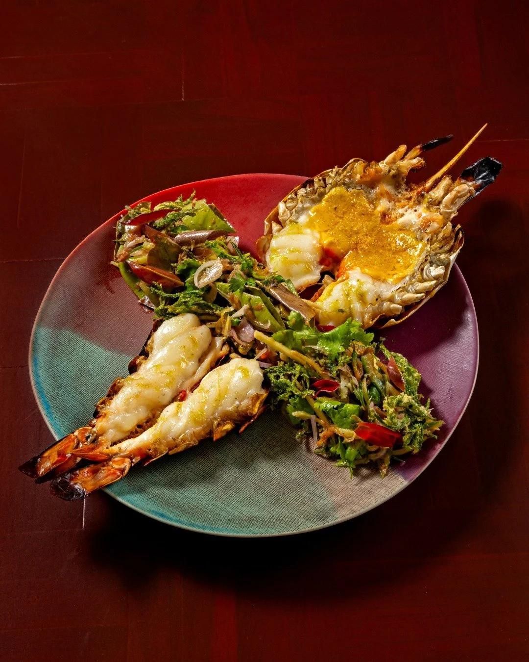 Grilled river prawn. A bright salad. The funky kick of naam-prik-kapi and the crisp finish of fried cha-om. A plate built on contrast.
