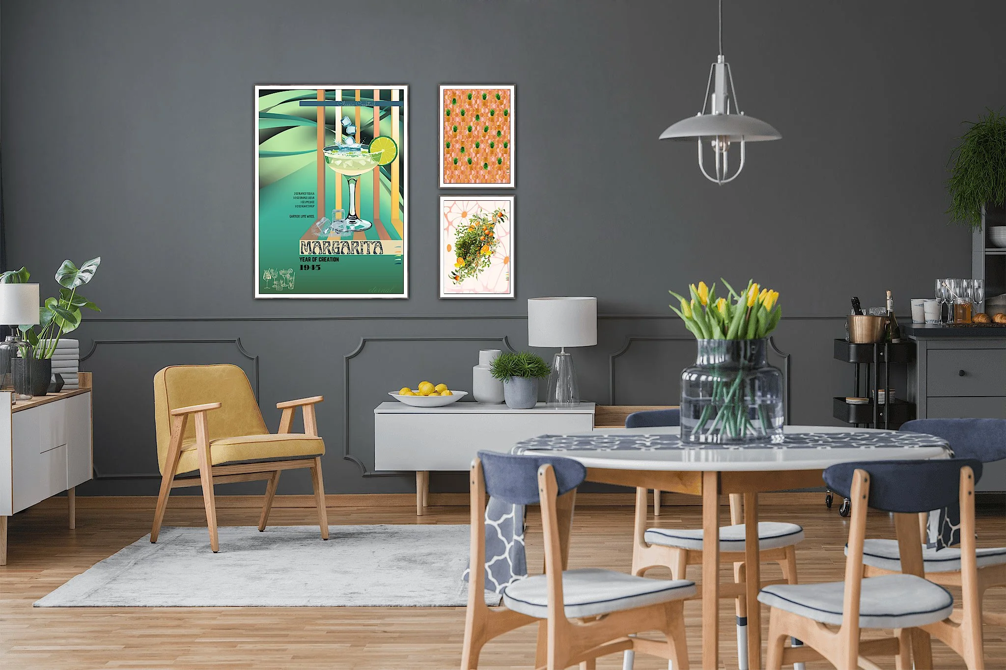 A modern dining room with a round table, four chairs with blue cushions, and a vase of yellow tulips on the table. In the background, there is a gray wall with framed posters, a white sideboard with a lamp, lemons, and plants, and a gray cabinet with