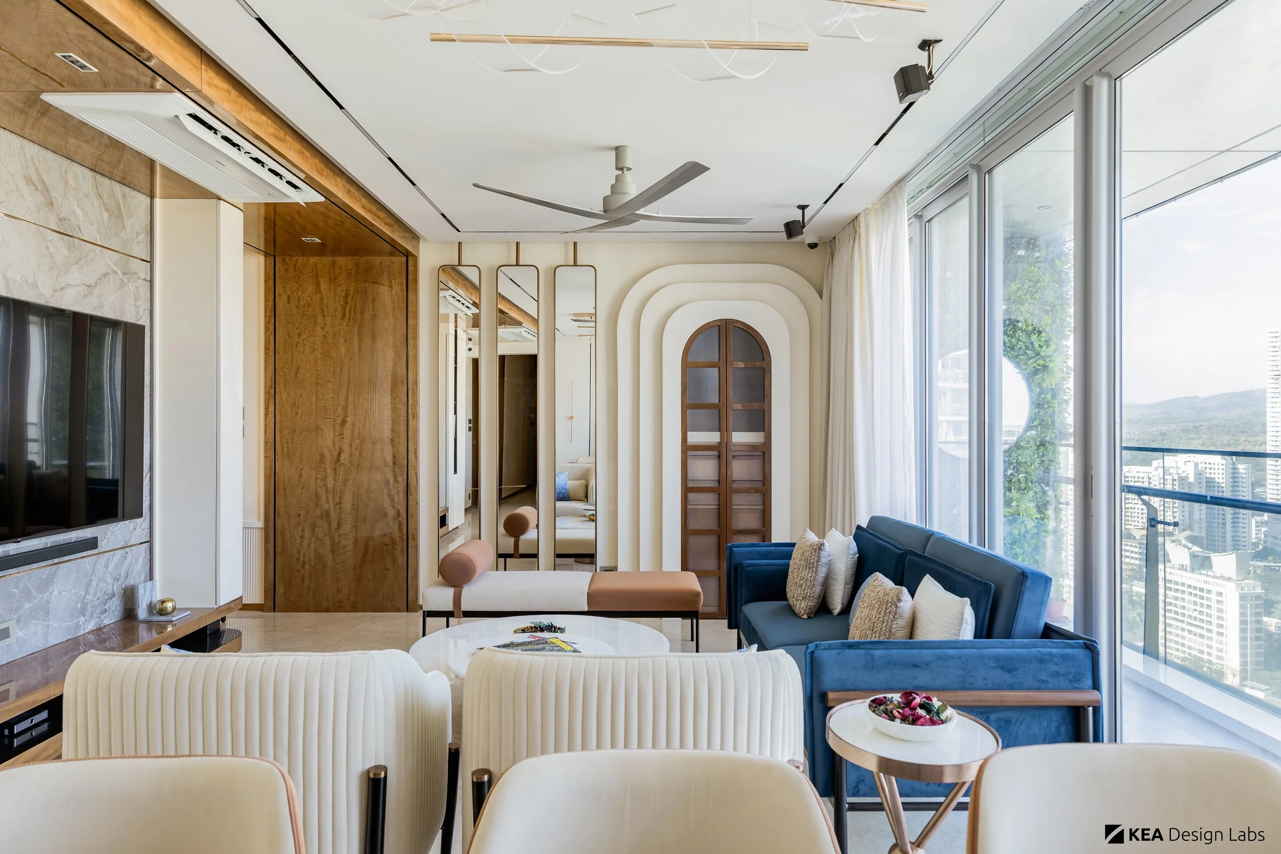 1-mandir-living-room-wood-ceiling-mirror-wall-premium-luxury-design-ideas-marble-tv-wall-blue-sofa-wood-paneling-dining-table-rose-gold-mumbai-home.jpg