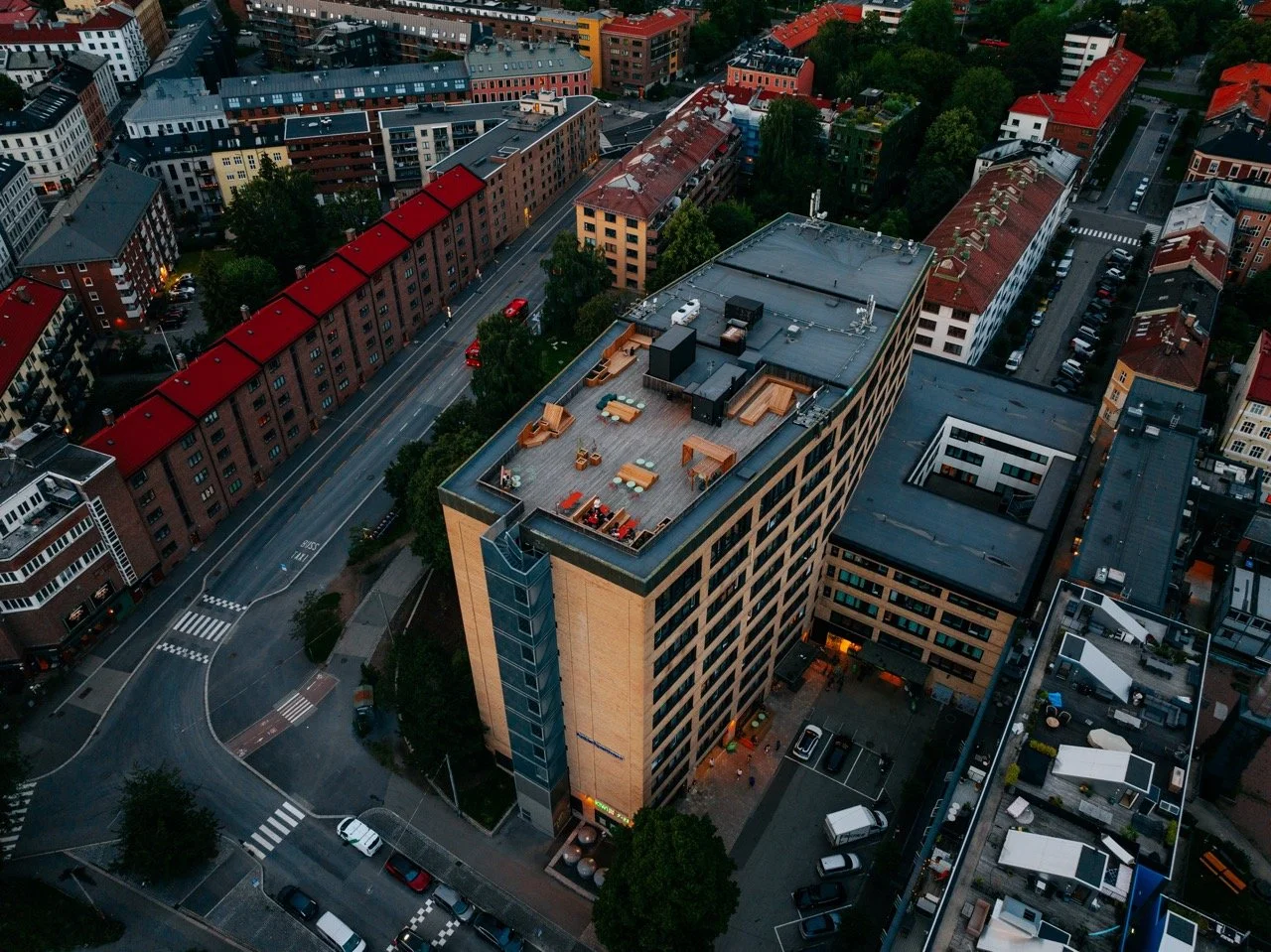 Aerial view of urban neighborhood with multi-story buildings and city streets.