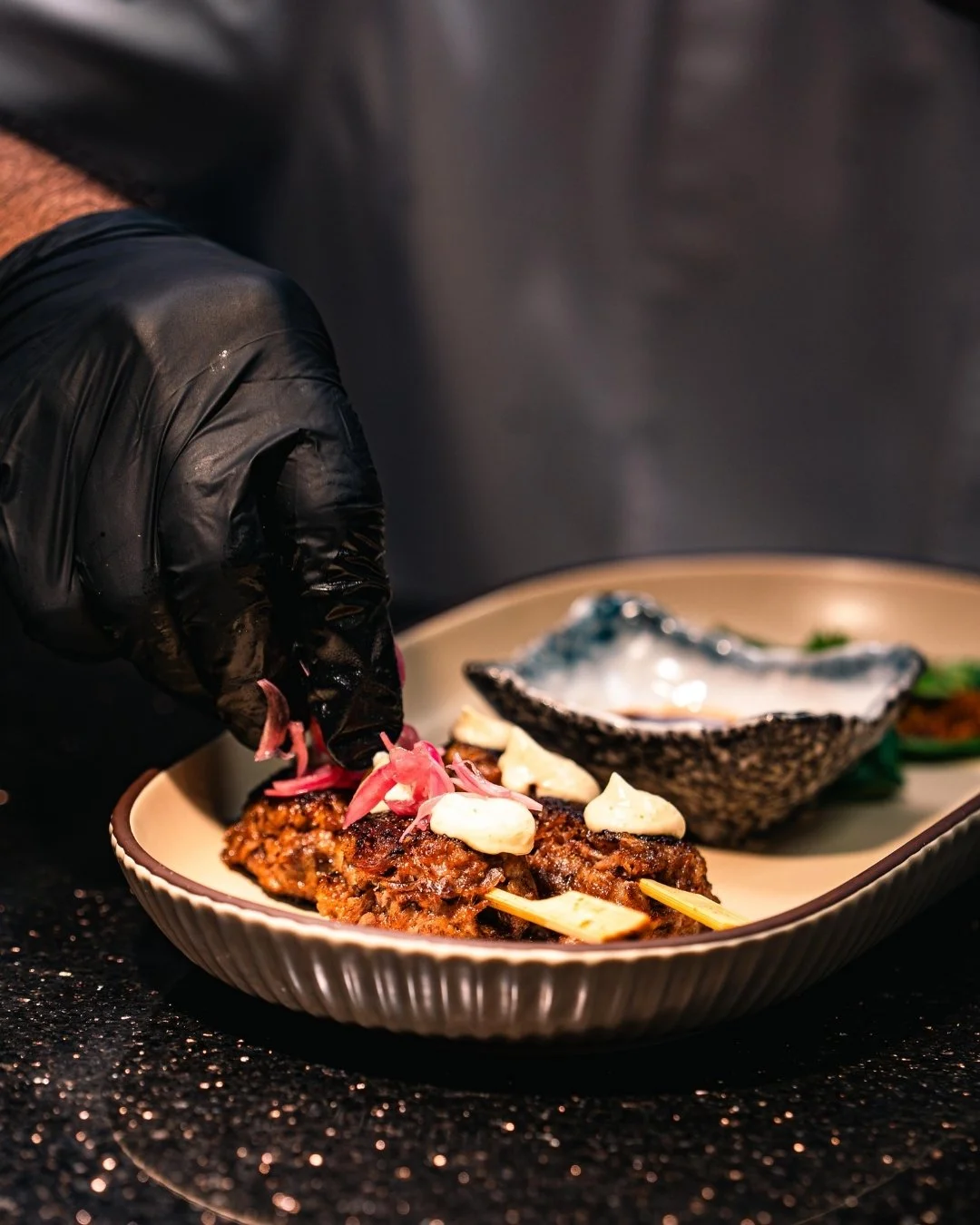 From the grill to the plate, introducing our Oxtail Tsukune. Tender oxtail meatballs glazed in smoked shoyu, finished with yuzu kosho aioli, pickled shallots, and silky egg yolk.

A bite that&rsquo;s smoky, rich, and unmistakably Pan-Asian.
Now avail