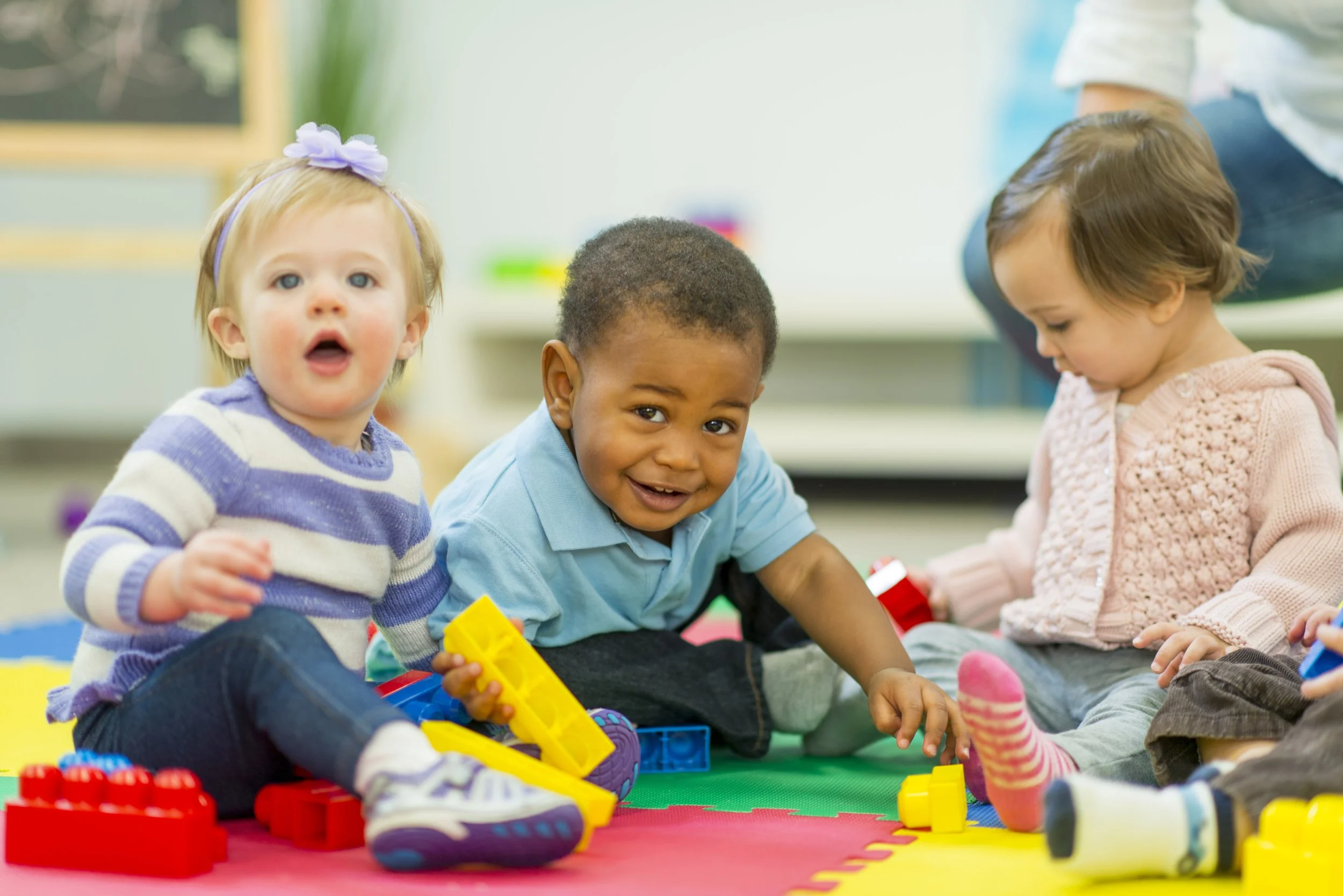 Toddlers interacting with blocks at daycare center
