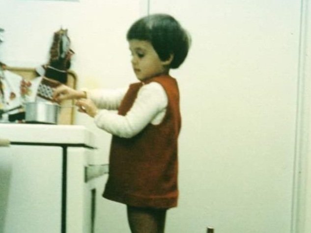 A young Maryke, as a little girl, enjoying her time in the kitchen, sparking her lifelong passion for cooking.