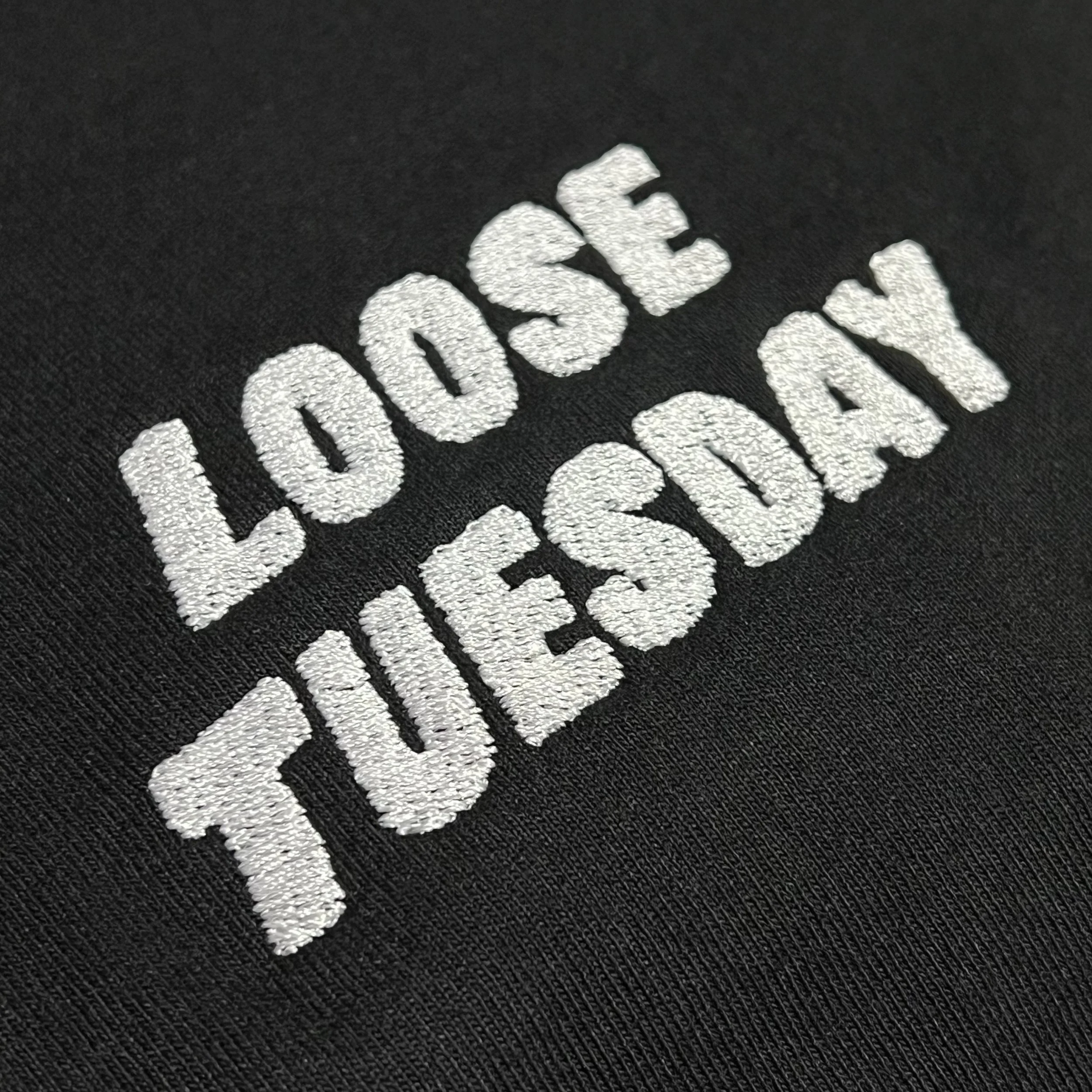 Loose Tuesday Everyday Tee — embroidered logo detail in white on black