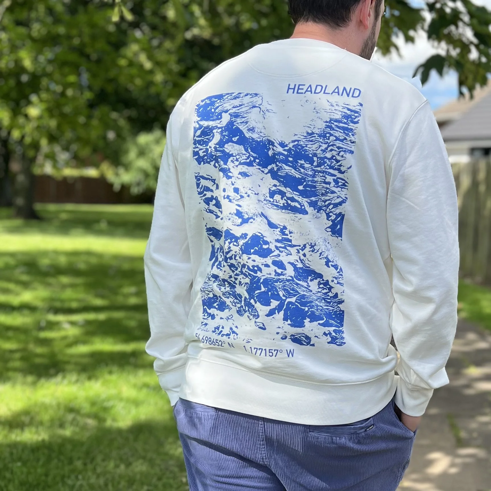 Model wearing loose tuesday headland sweater showing distorted wave pattern in blue on white
