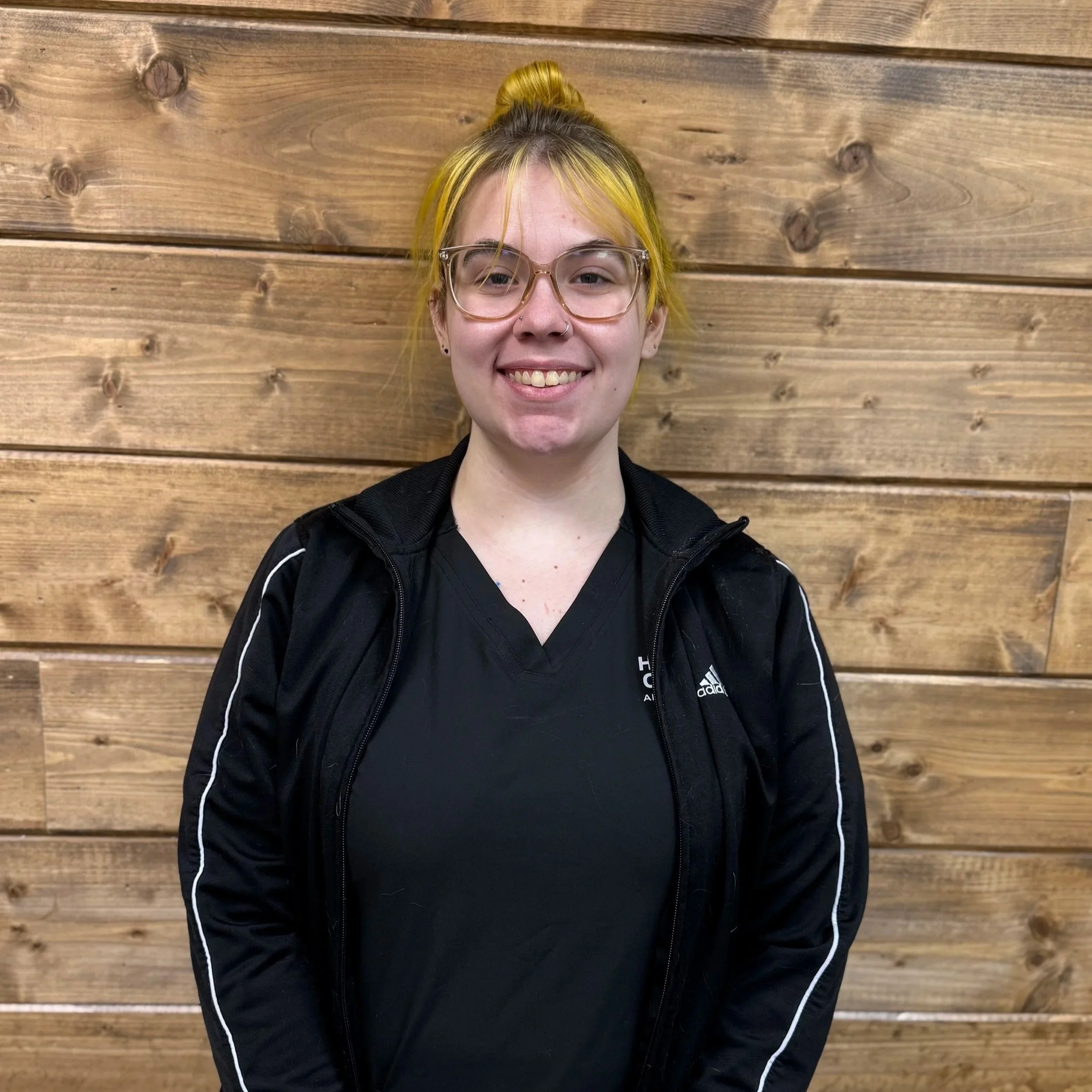 A happy black and white dog with pointy ears, open mouth, and a joyful expression.