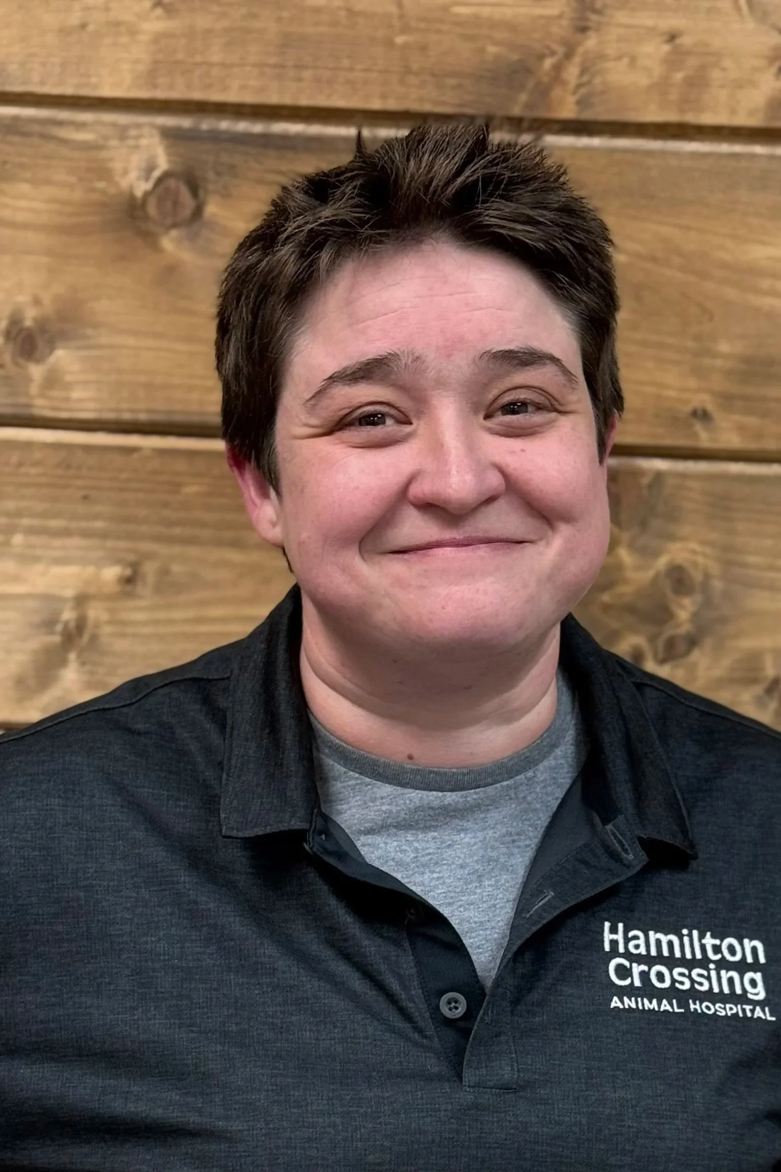 Profile of a gray dog with piercing eyes against a black background.