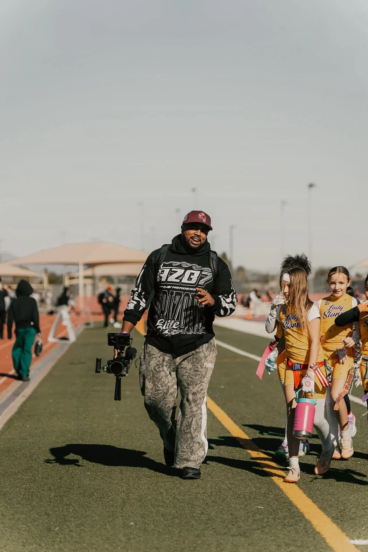 A man enjoying the moment filming a sporting event