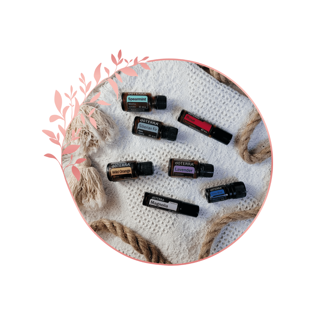 Huiles essentielles Doterra de différentes senteurs disposées sur une surface en tissu, entourées de cordes et d'une décoration en papier.