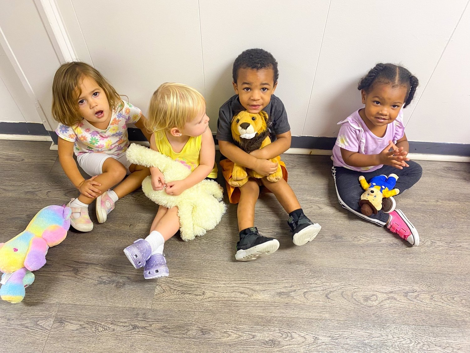Toddlers sitting together with their stuffed animals on a Sunday morning at North Lake