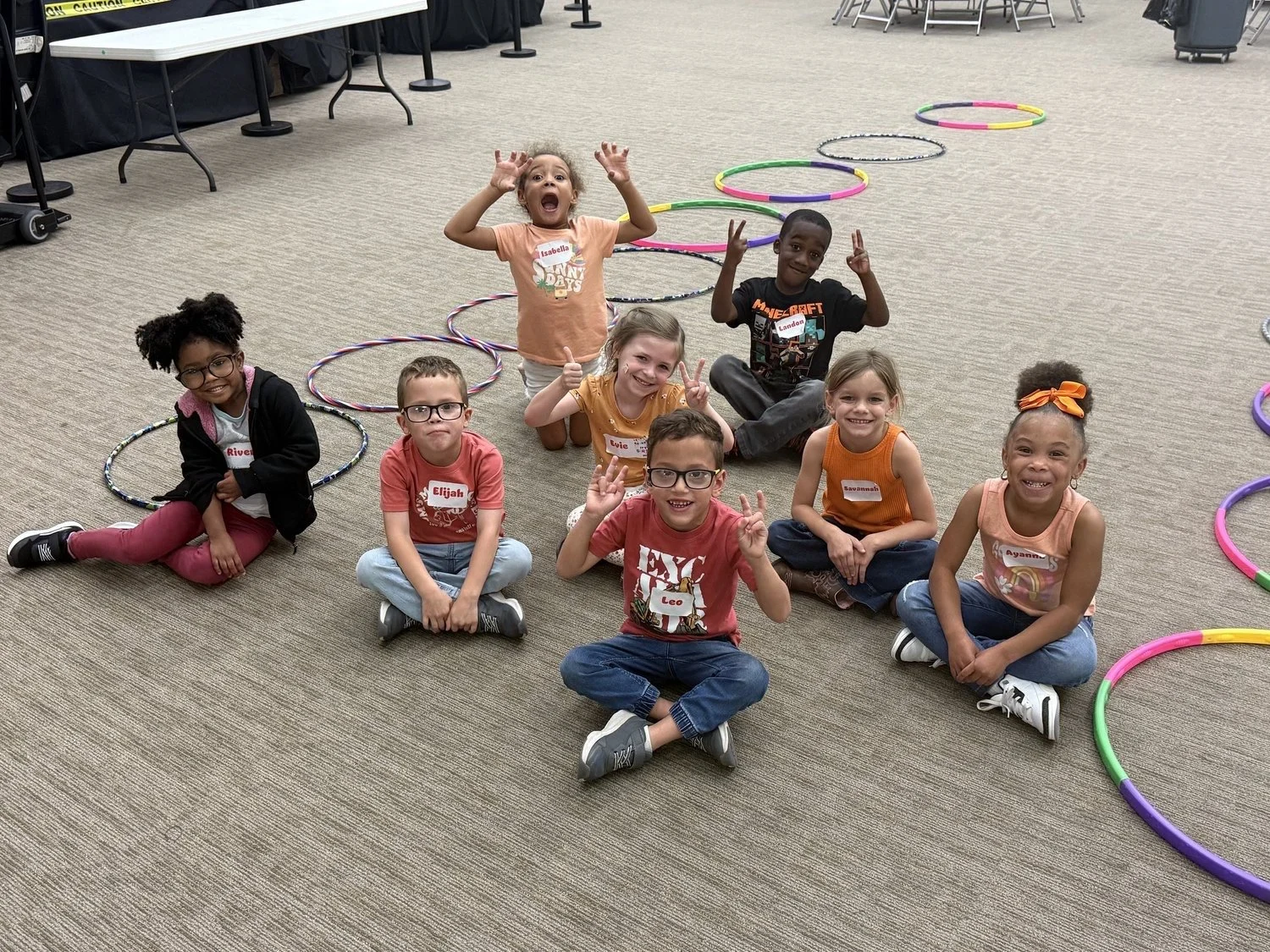 Children in the North Lake NOW after-school program playing a game with hula hoops
