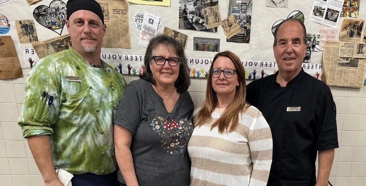 Members of the Operation Homebound kitchen team standing together in the church kitchen