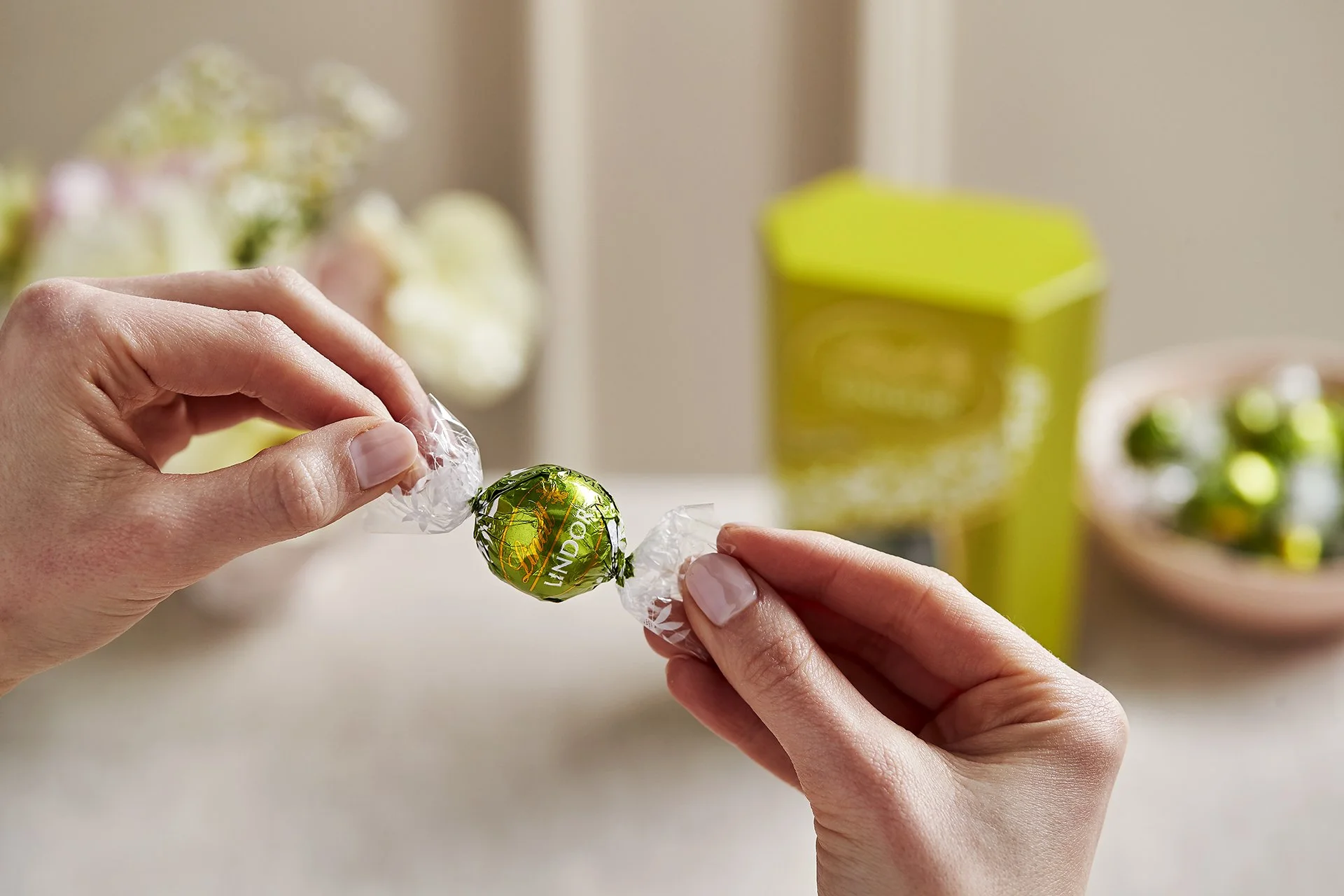 Pistachio Lindor truffle been held