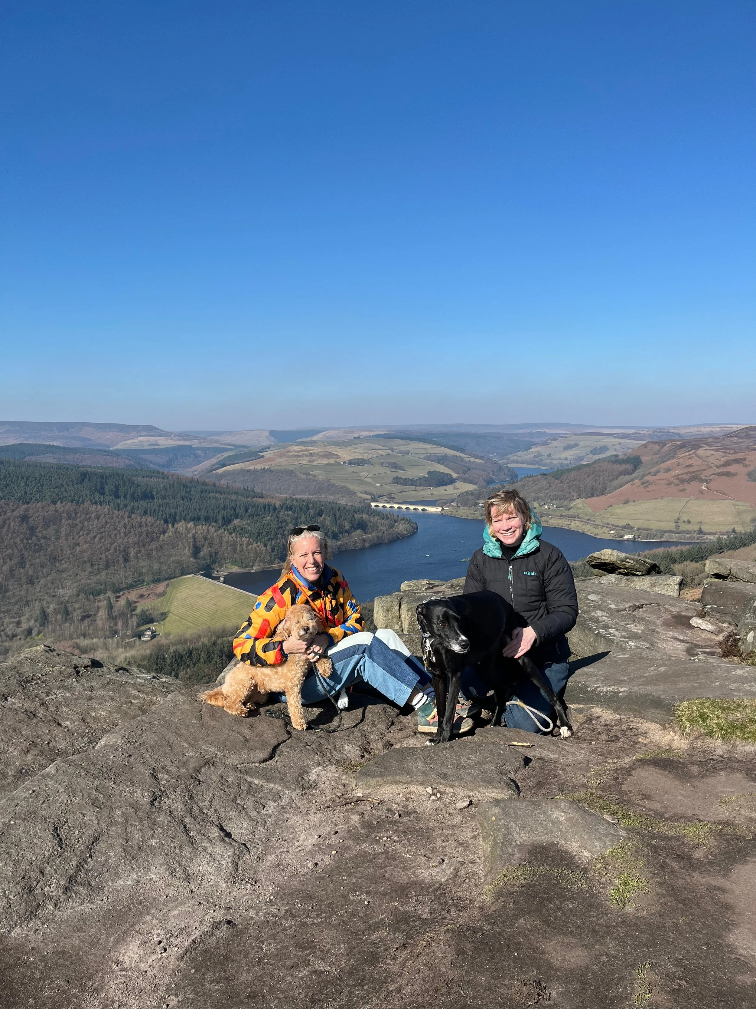 Dr Helen Underhill & Laura Hirst and dogs on top of a hill