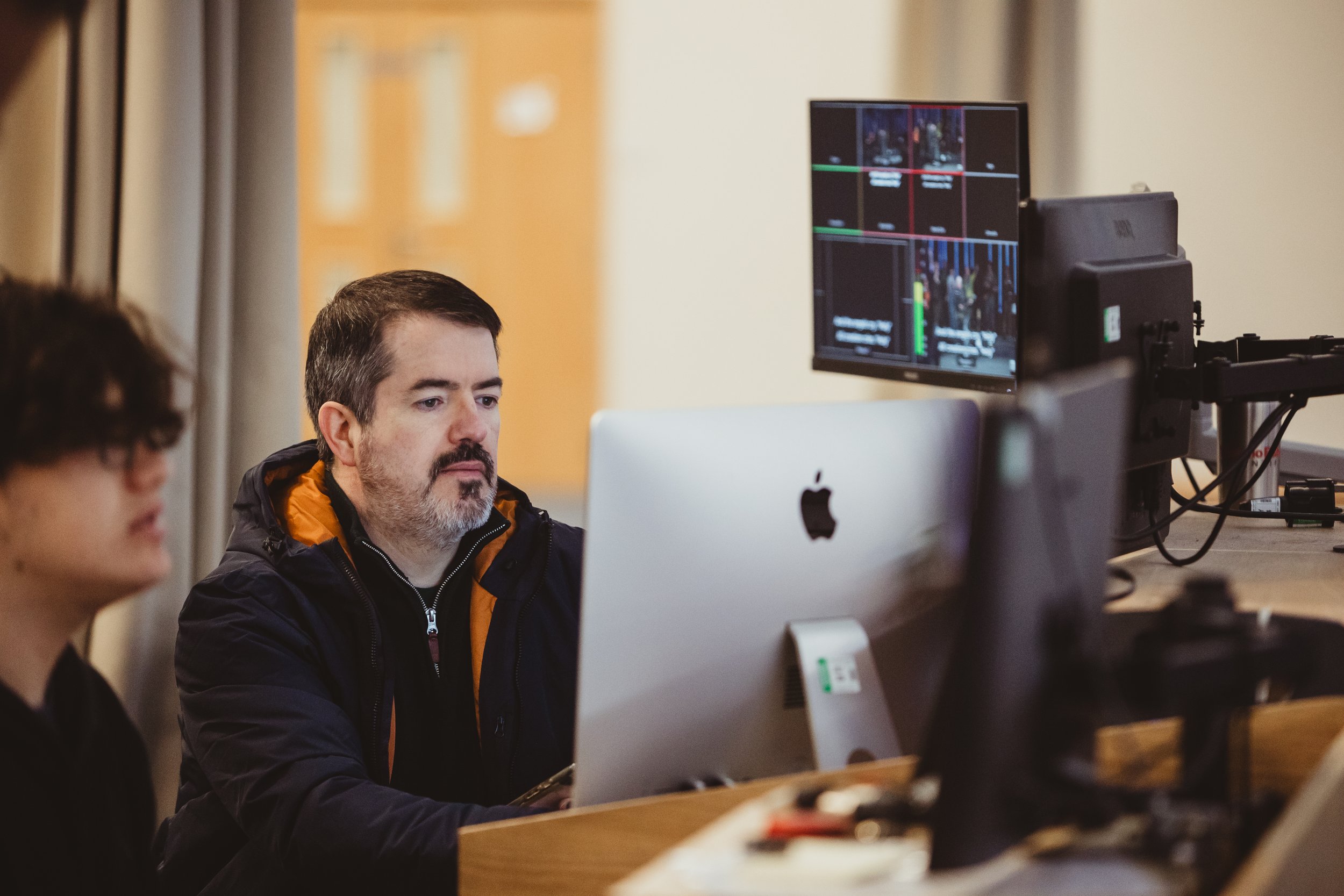 People running an AV desk during a worship time at church.