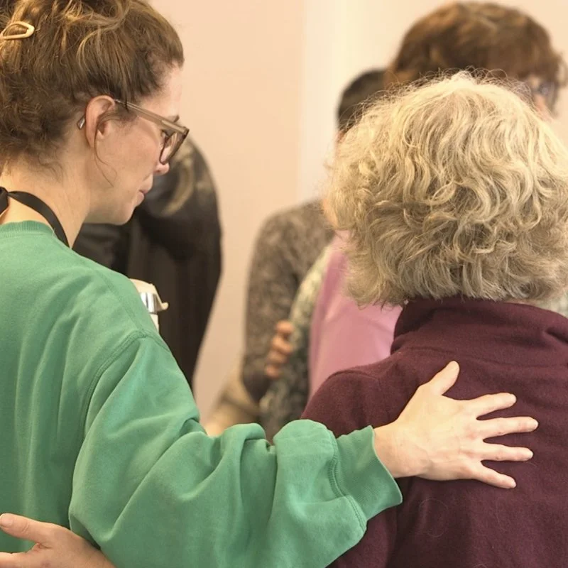 Two members of the church praying for one another