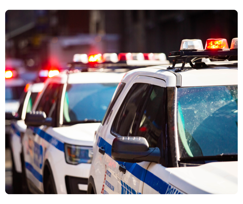 Front view of a red fire truck with lights on, featuring a hose and equipment on the bumper, marked with the number 421.