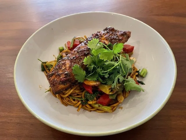 The finished dish of Asian Salmon with vegetables and noodles