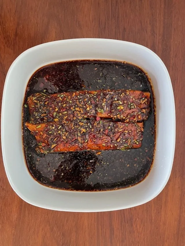 Salmon fillets resting in an Asian marinade