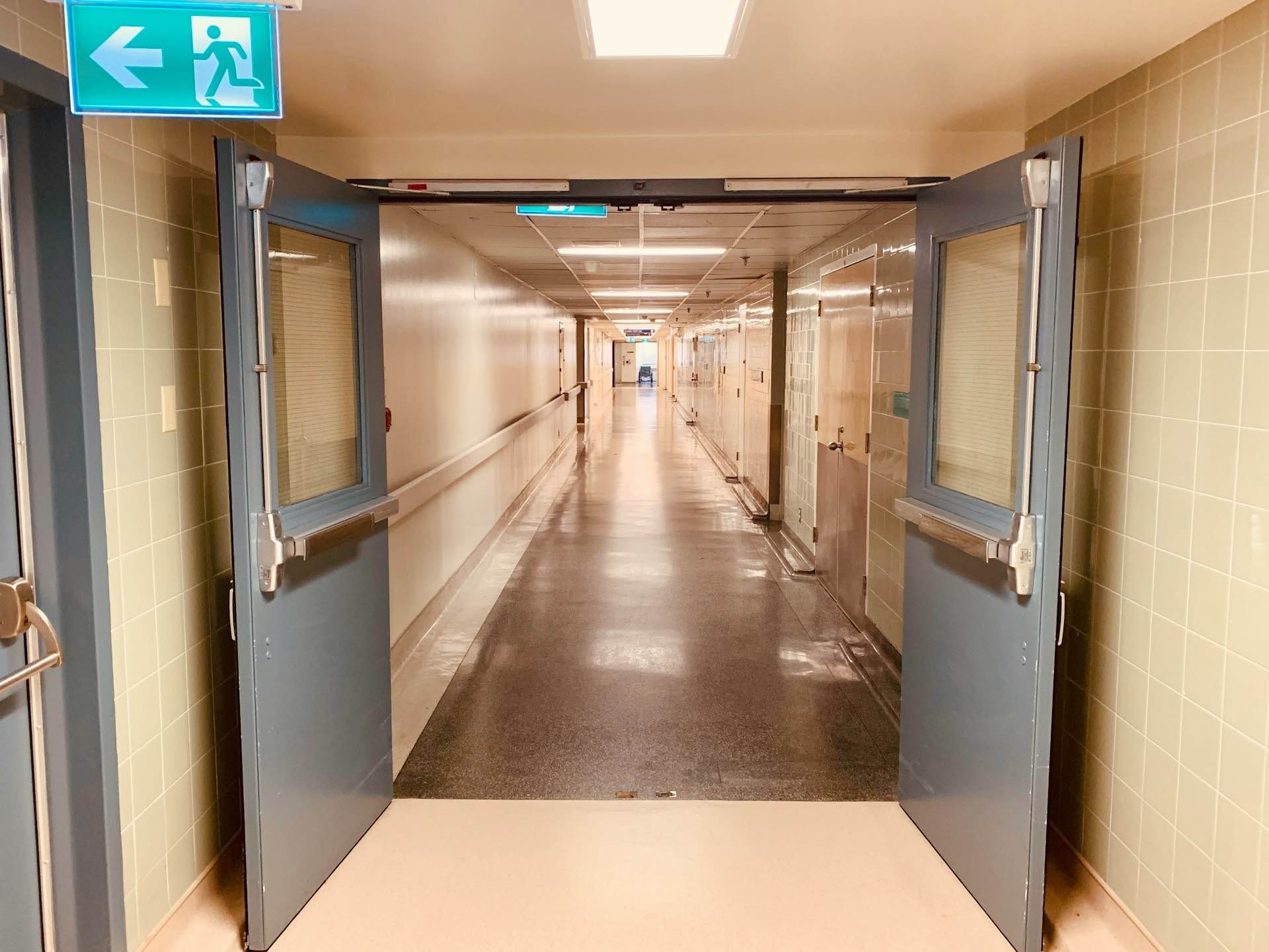 An eerie hospital corridor, stark empty and sinister