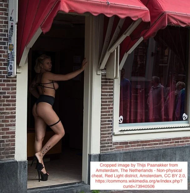 A scantily-clad prostitute in a doorway in Amsterdam's Red-Light District