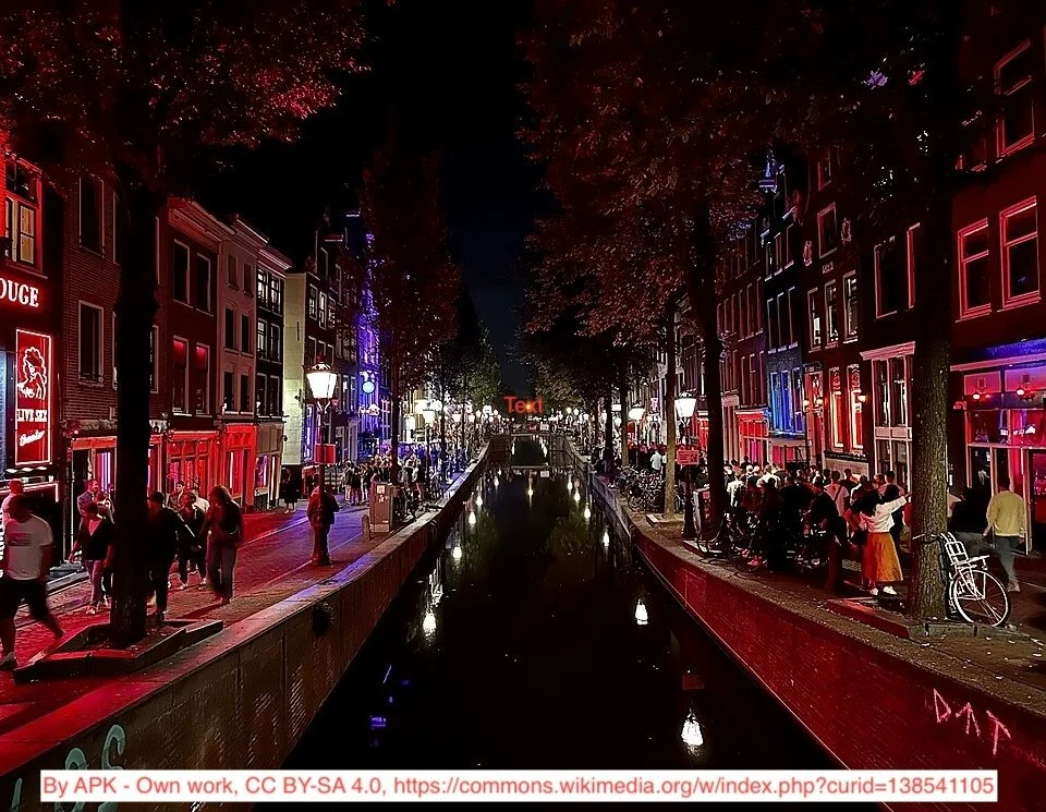 Bright lights reflect off the canal in Amsterdam's Red-Light District