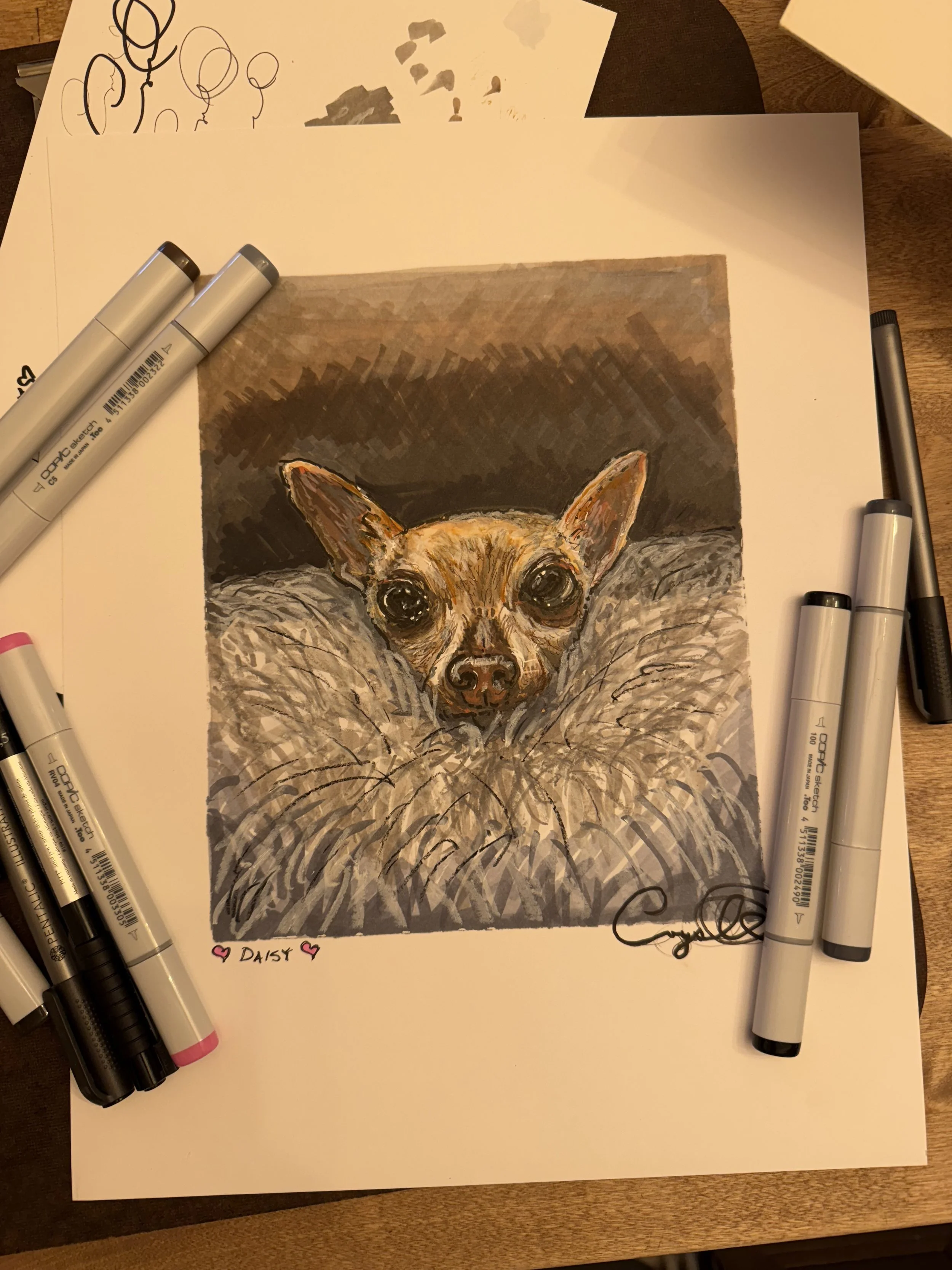 A hand-drawn illustration of a dog with large eyes and pointy ears, surrounded by watercolor shading. Several markers are placed around the artwork, and there is a handwritten note at the bottom that reads "Daisy" with pink hearts.