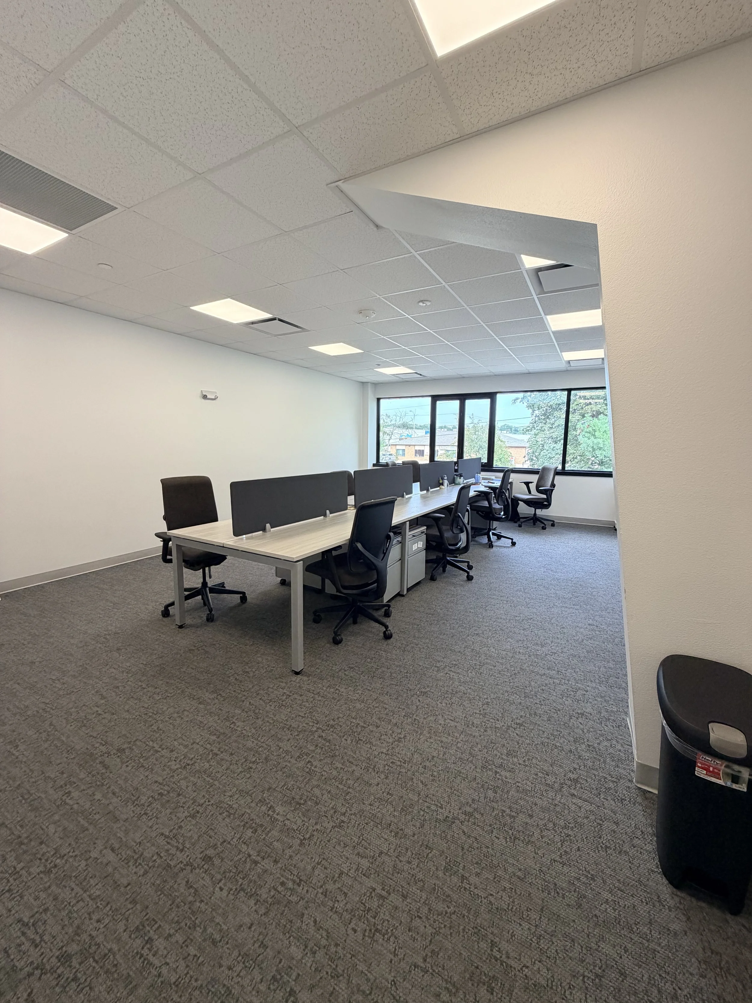 Coworking space with desks and natural light at Dream City in Iowa City