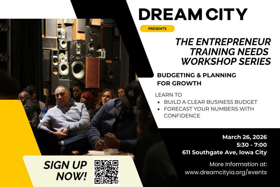 Two people are standing at a wooden table, writing on a large sheet of paper with sticky notes in a restaurant or cafe with large windows and outdoor seating visible through the windows.