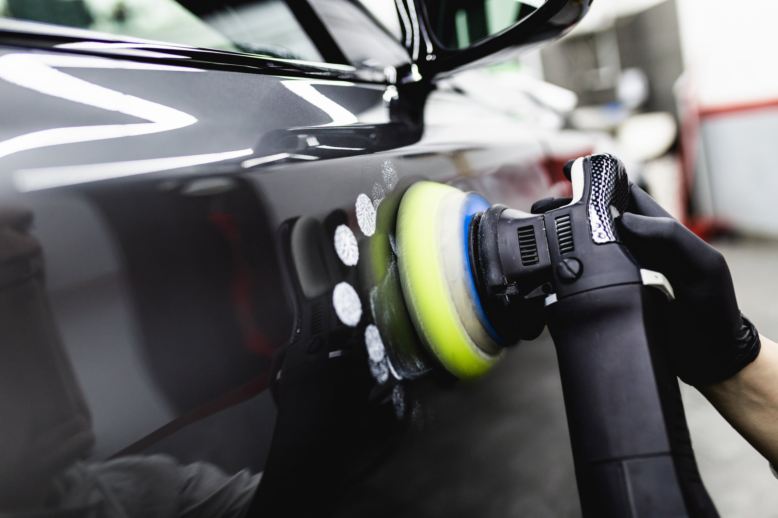 car-detailing-worker-with-orbital-polisher-auto-repair-shop-selective-focus.jpg
