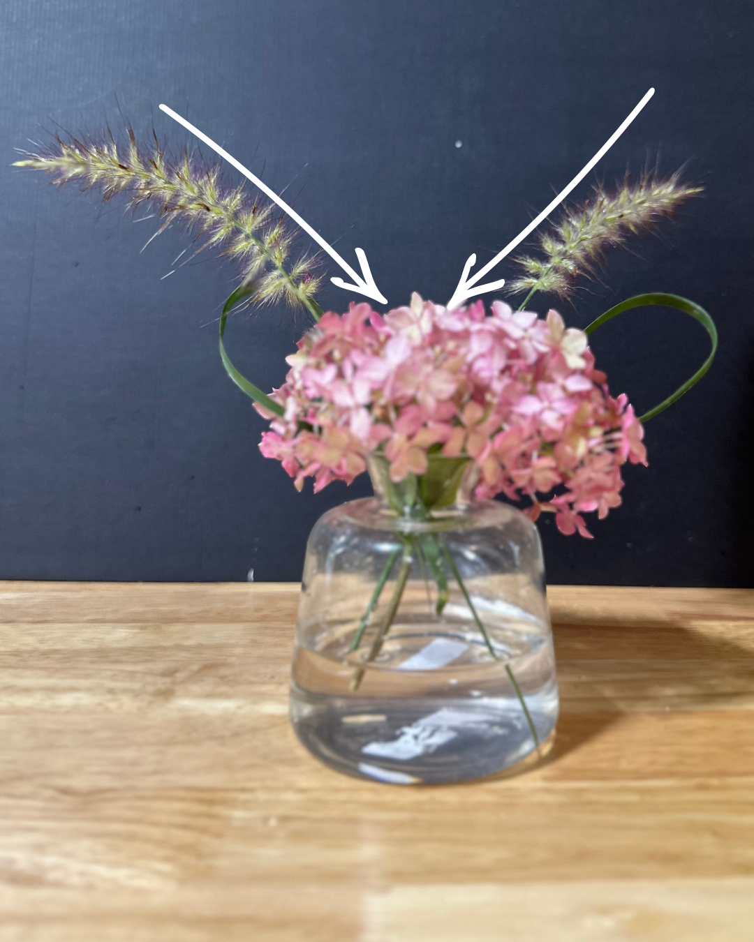 cross some of your taller filler in a X shape through the middle of the hydrangea bloom 