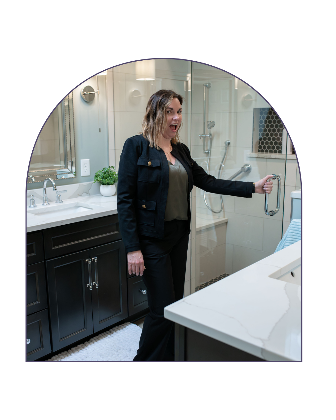 Woman with blonde hair opening a glass shower door in a modern bathroom.