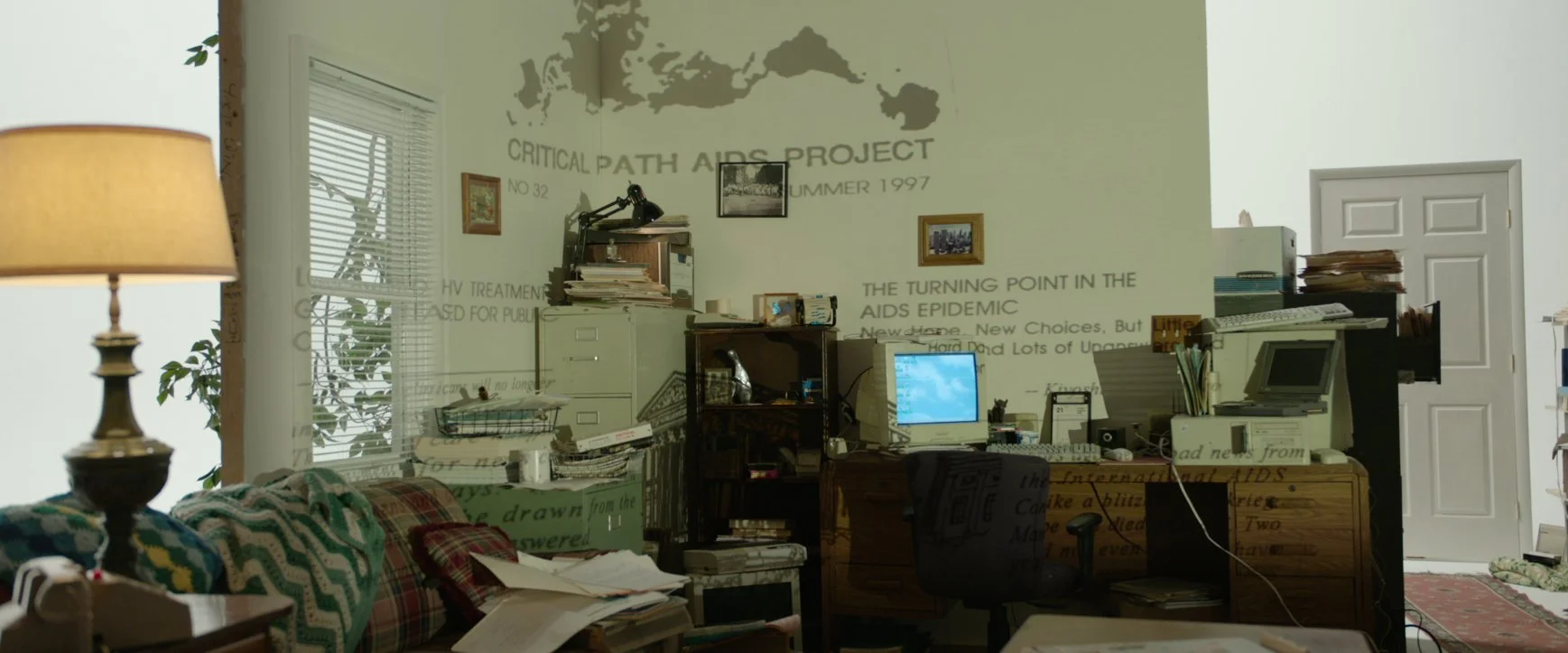 A page from the Critical Path AIDS Project projected on the set of Kiyoshi's apartment