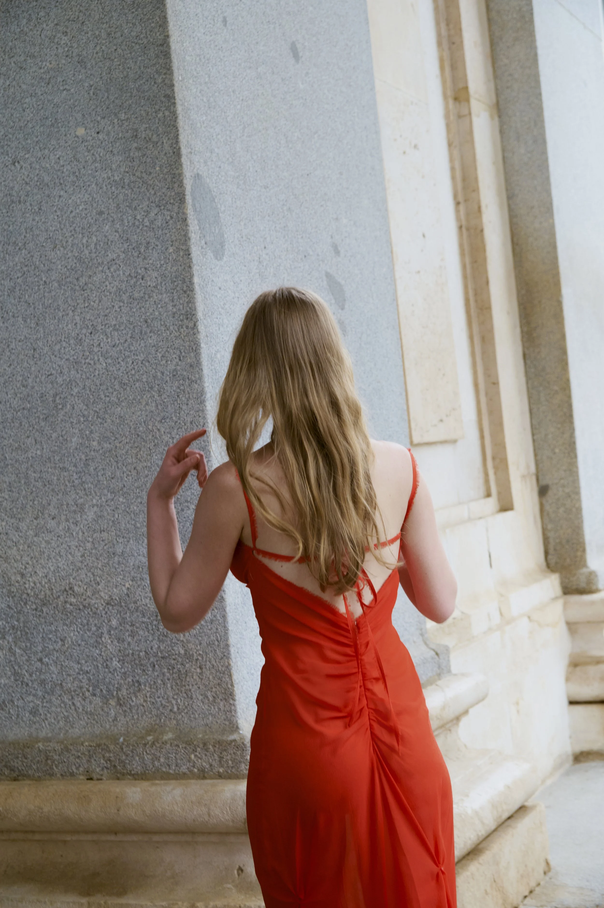 Red couture dress in silk georgette with elegant draping and open back