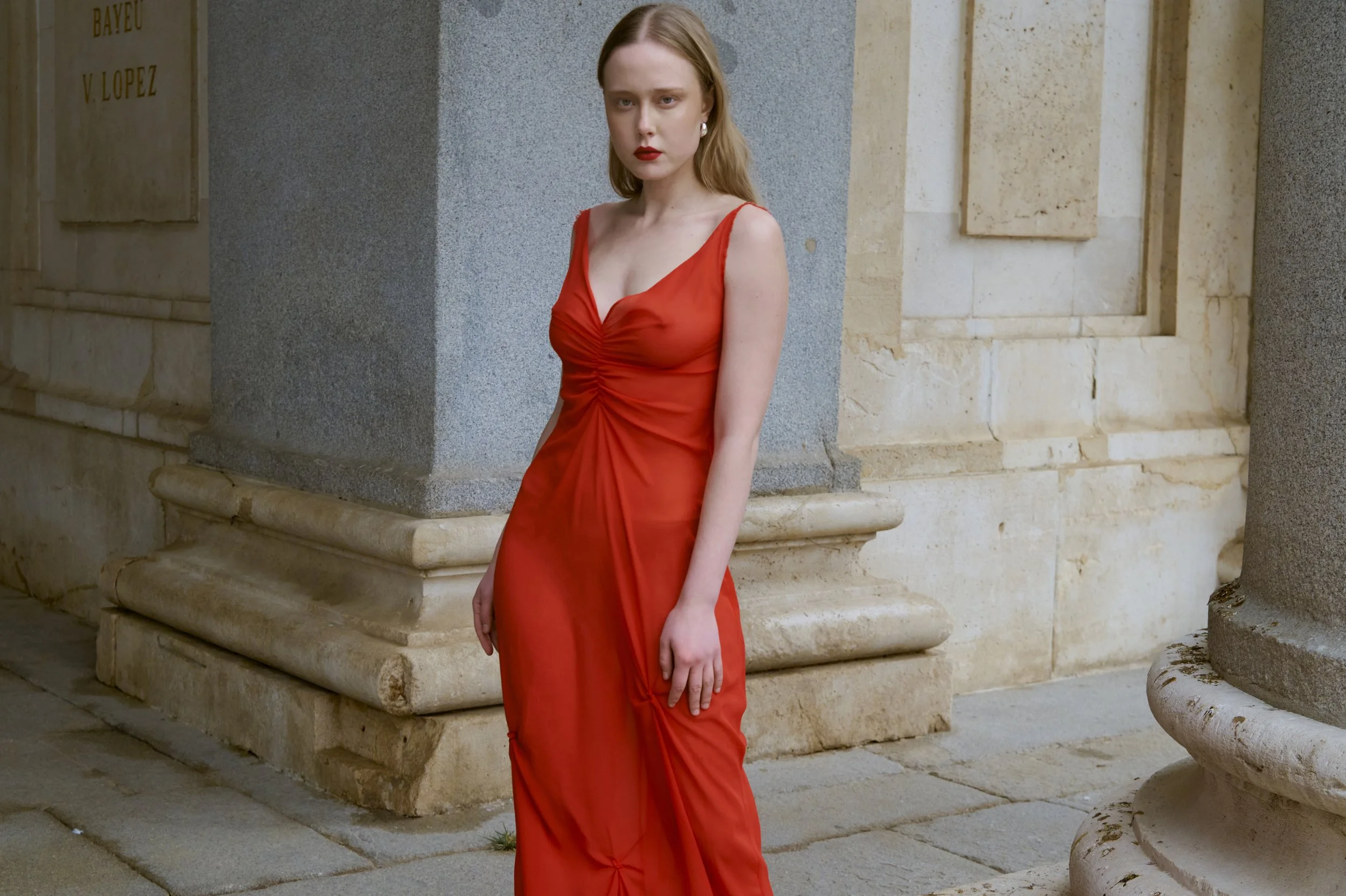 Scarlet red silk dress with minimalist couture lines and fluid movement