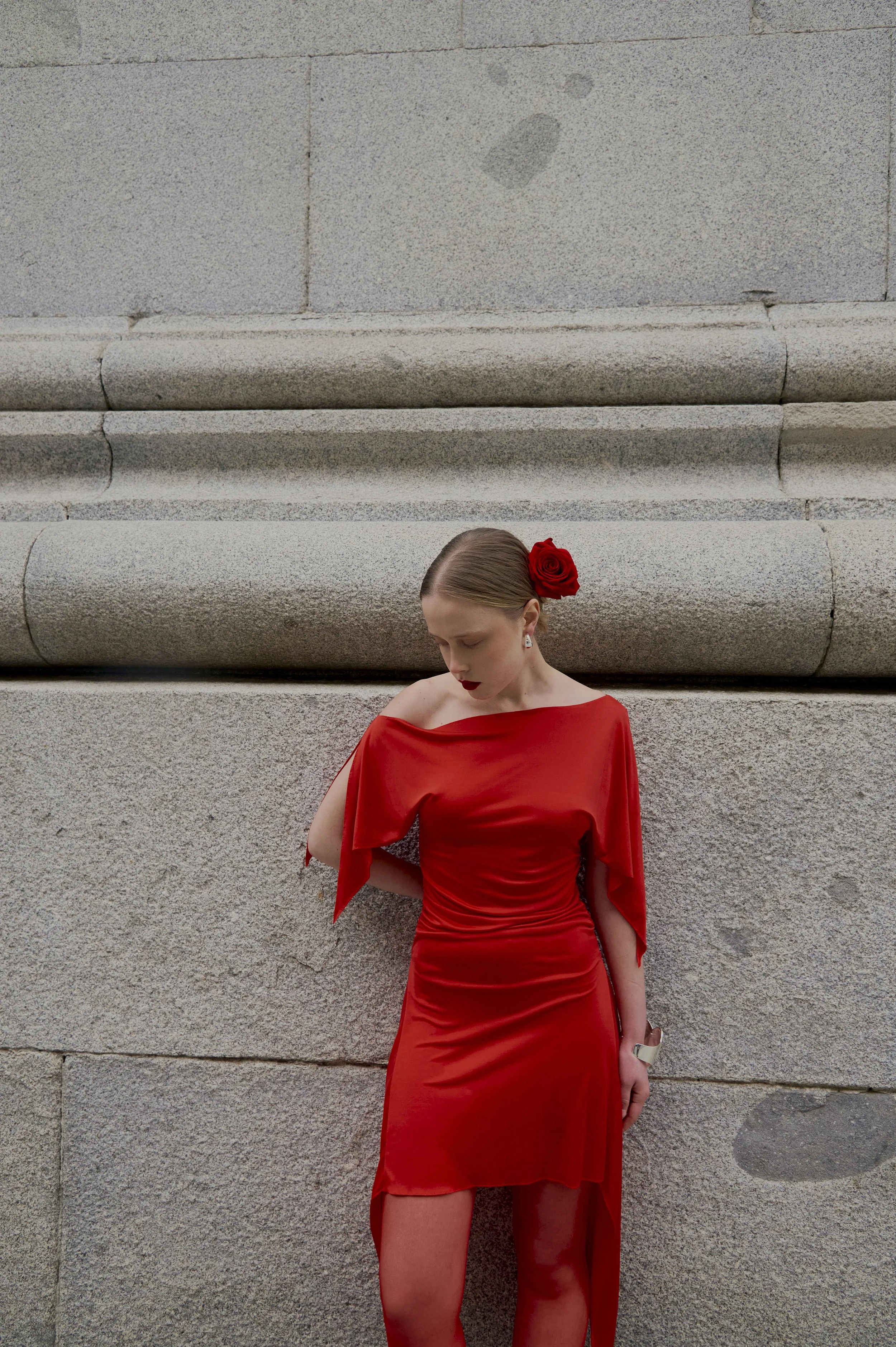 Elegant red silk evening dress with sculptural drape and refined movement
