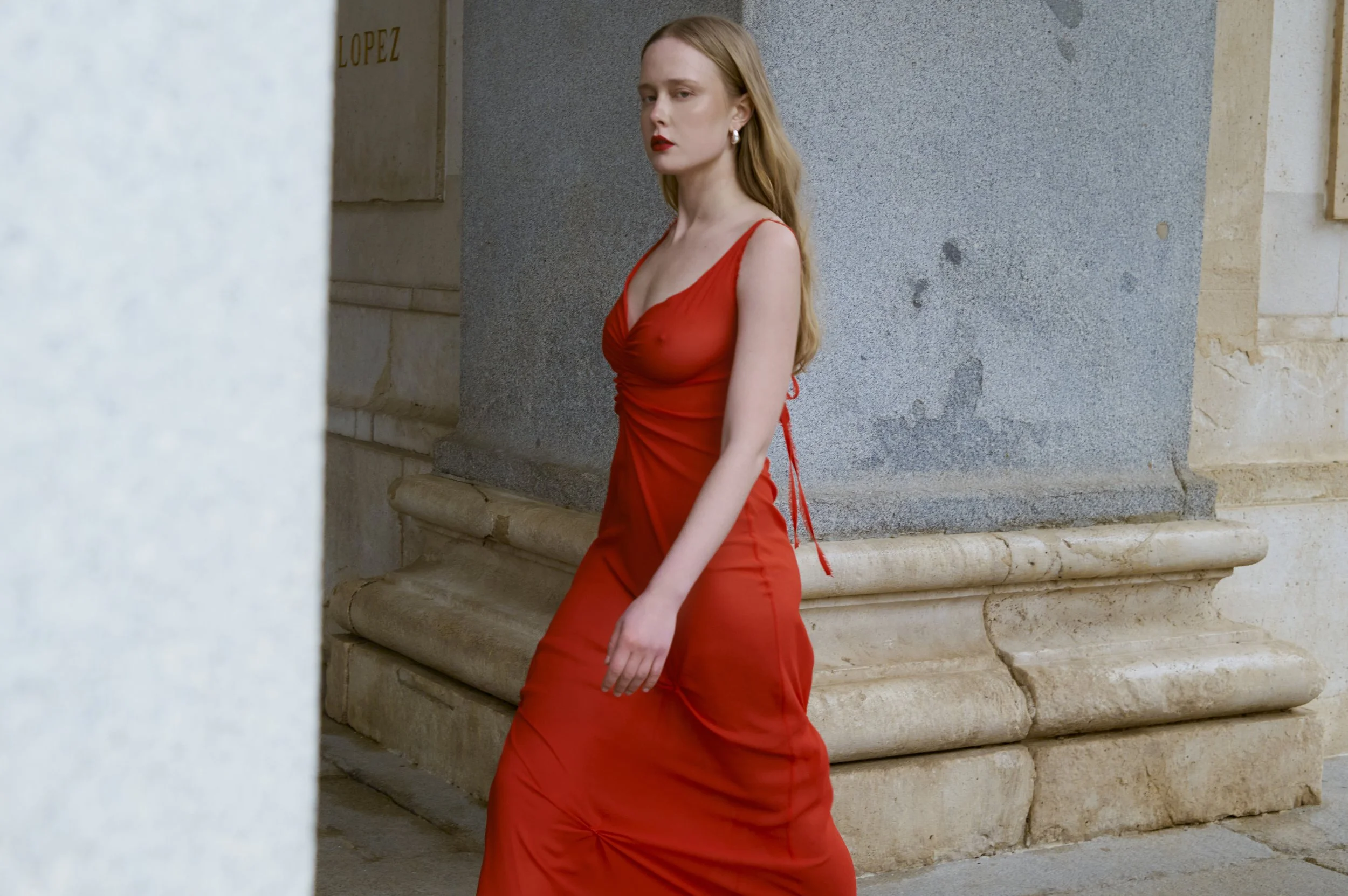 Scarlet red silk dress with minimalist couture lines and fluid movement