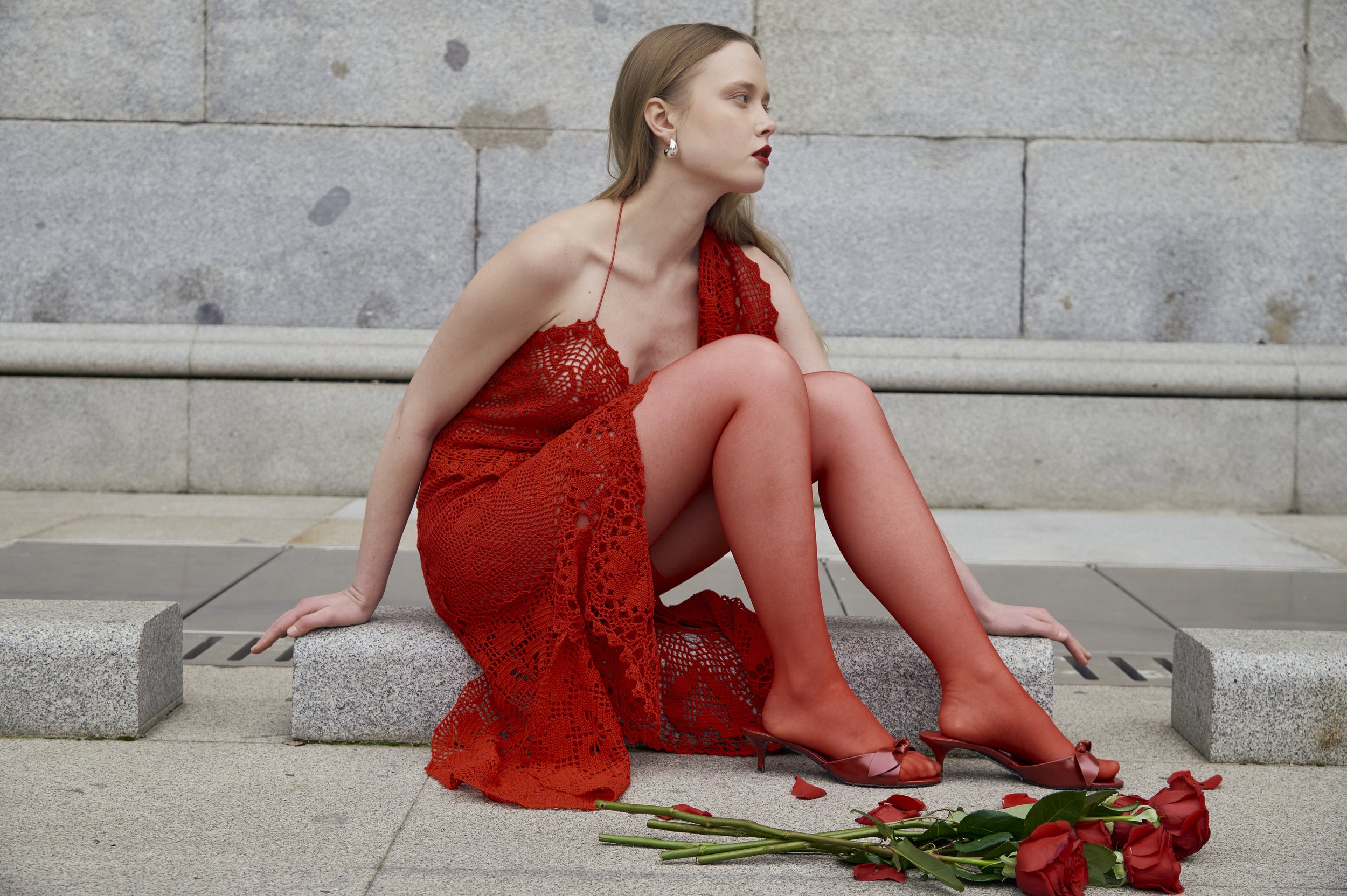 Couture red lace dress featuring handmade crochet and fluid draping