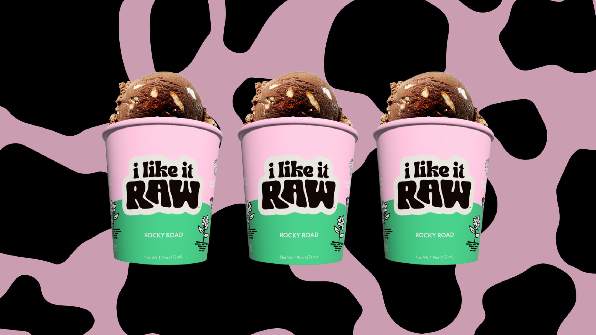 Three pints of ice cream labeled 'I like it RAW' with a pink and green cow print background.