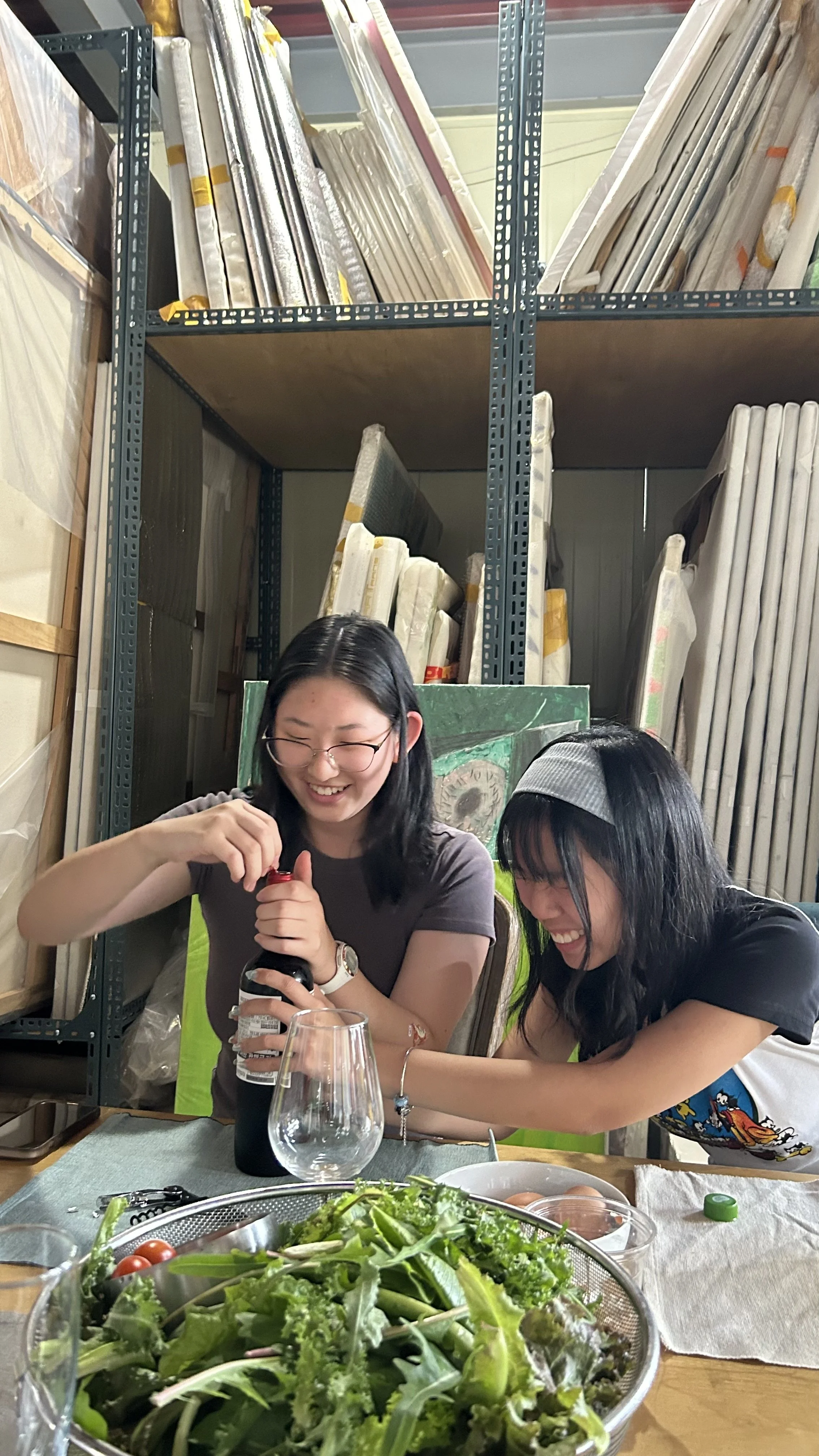 Minh Minh and I struggling to open a bottle of wine at Hyejin's house.