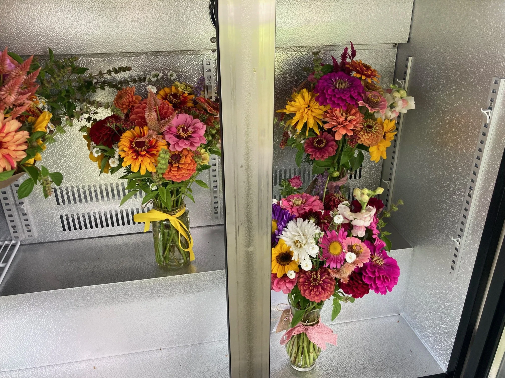vase arrangements in the flower cooler